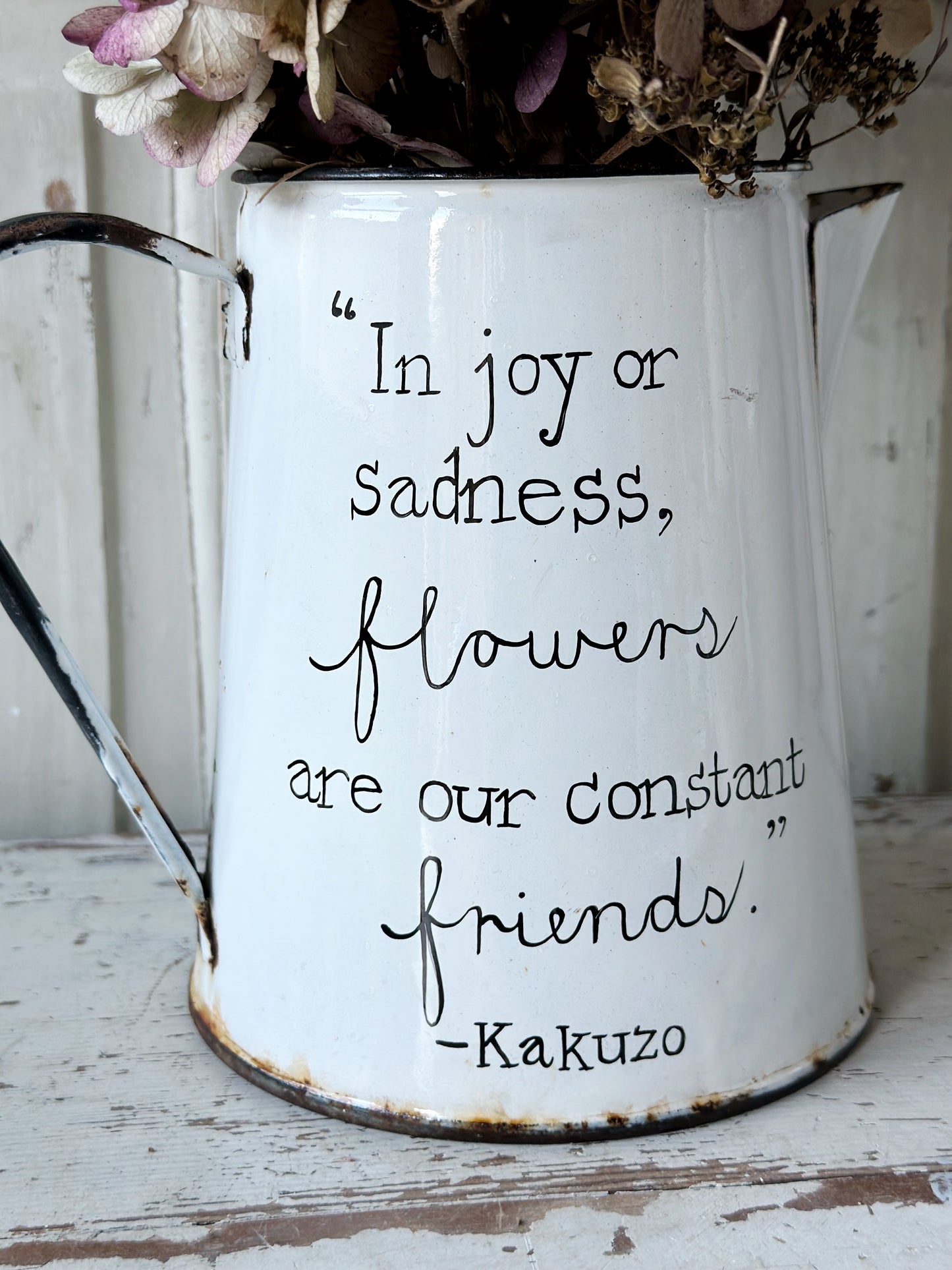 A hand painted quote on a beautiful Vintage white enamelware jug