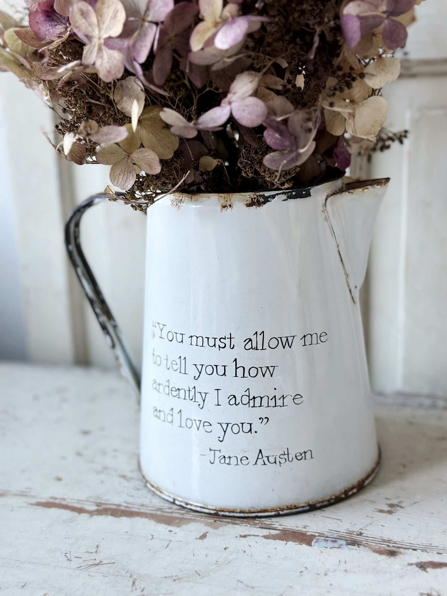A hand painted quote on a beautiful Vintage white enamelware jug