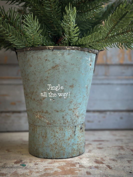 A Recycled Metal Mini Christmas Tree Bucket With A Hand Painted Quote
