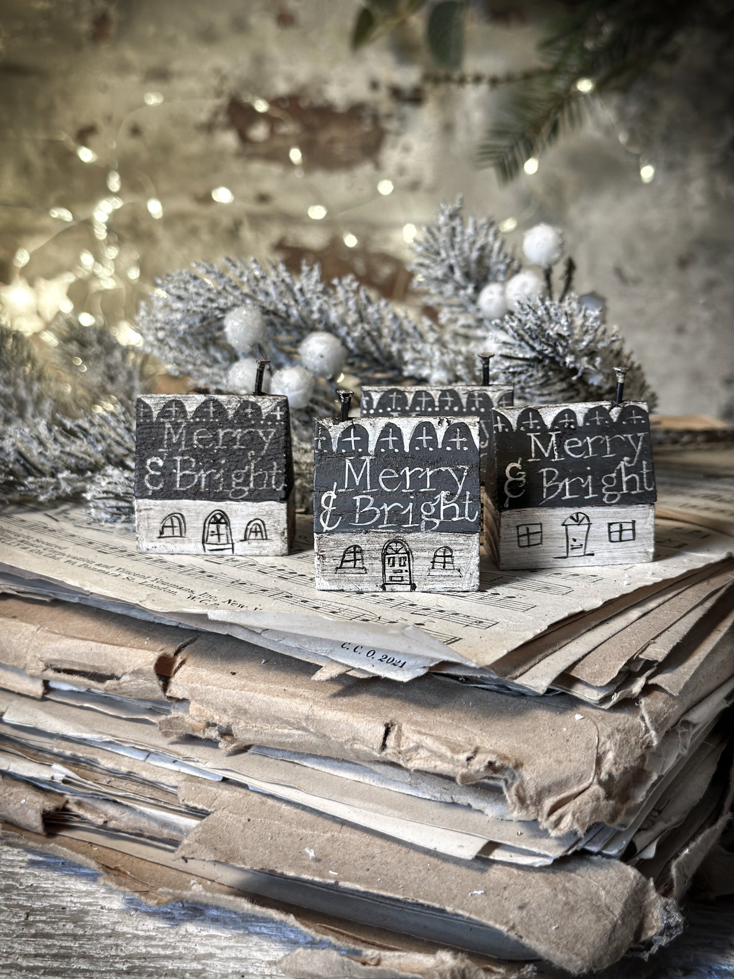 A pretty vintage German Erzgebirge Putz wooden village house painted with a Christmas quote