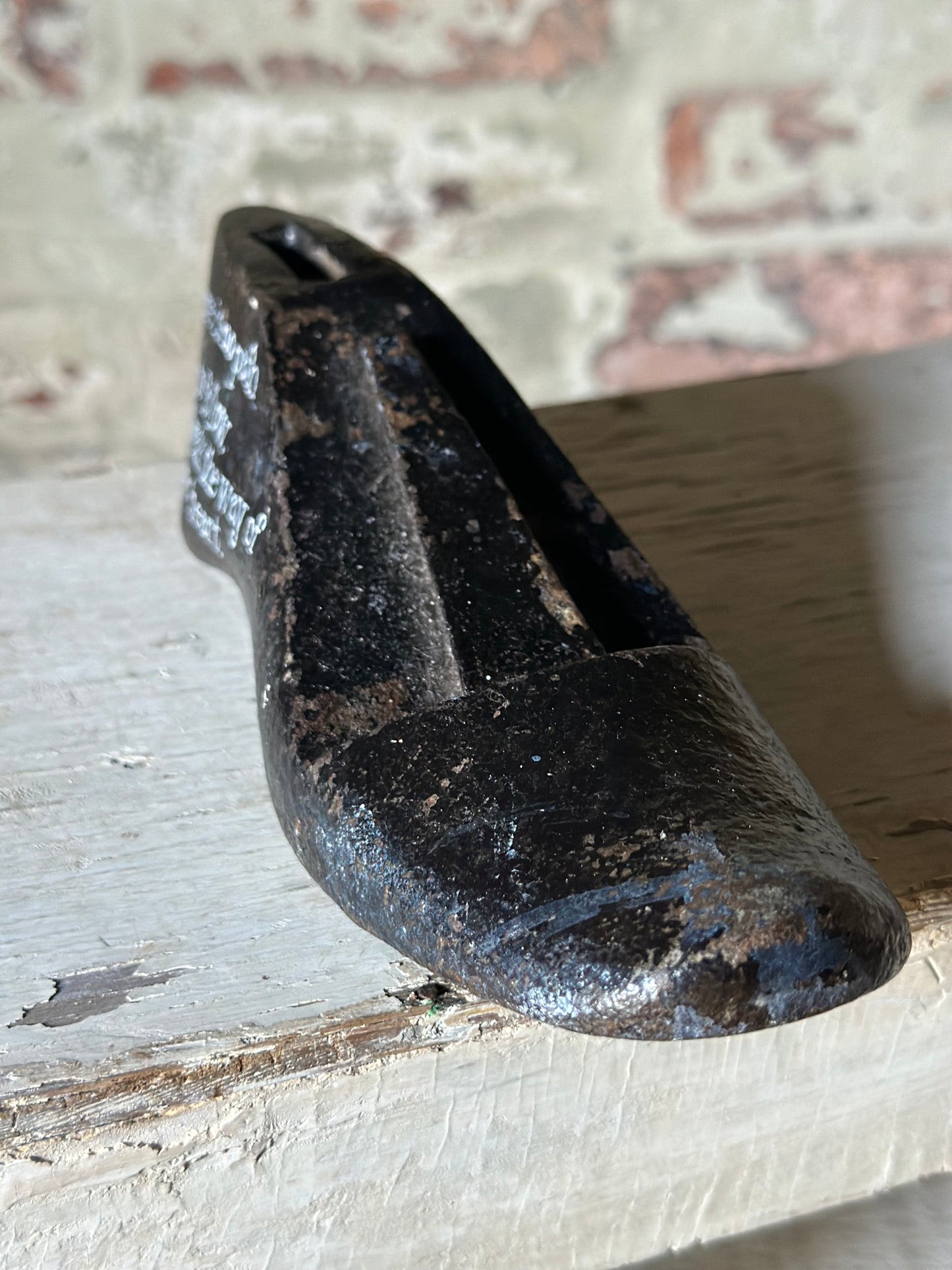 An antique cast iron painted adult’s shoe last.