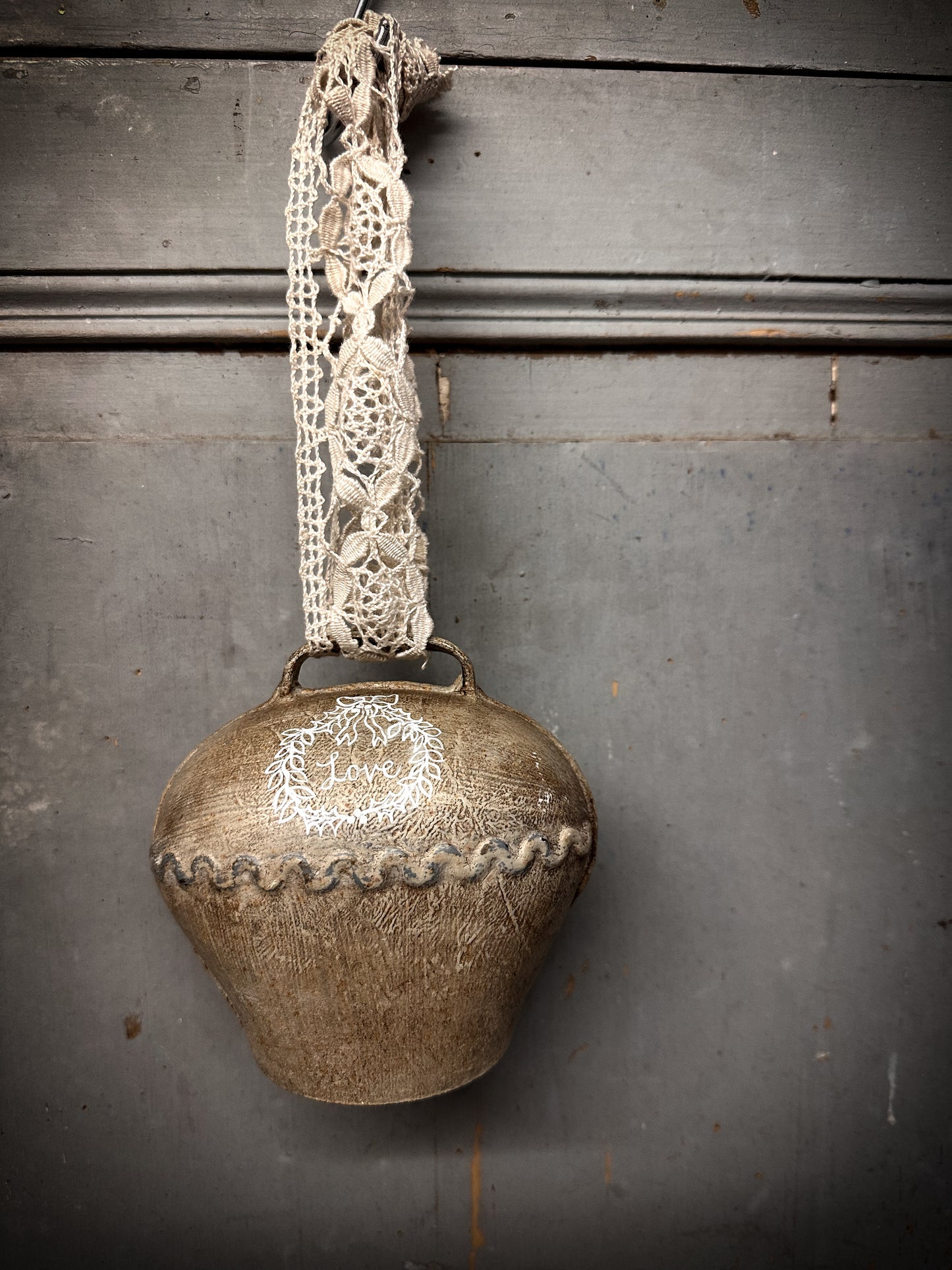 A Large Vintage Painted Cow Bell With a Hand Painted Quote