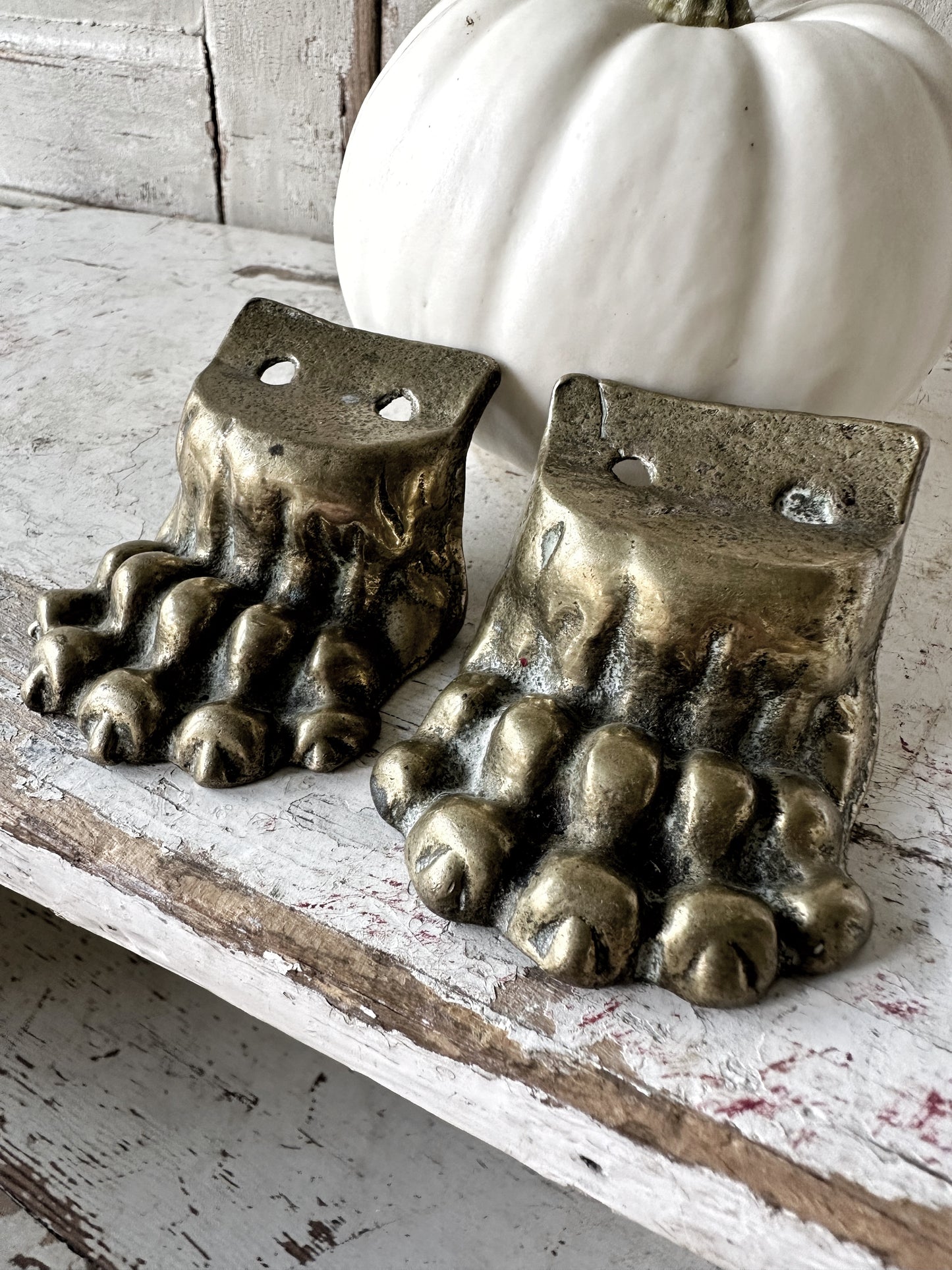A pair of two antique brass salvaged clawed feet for furniture