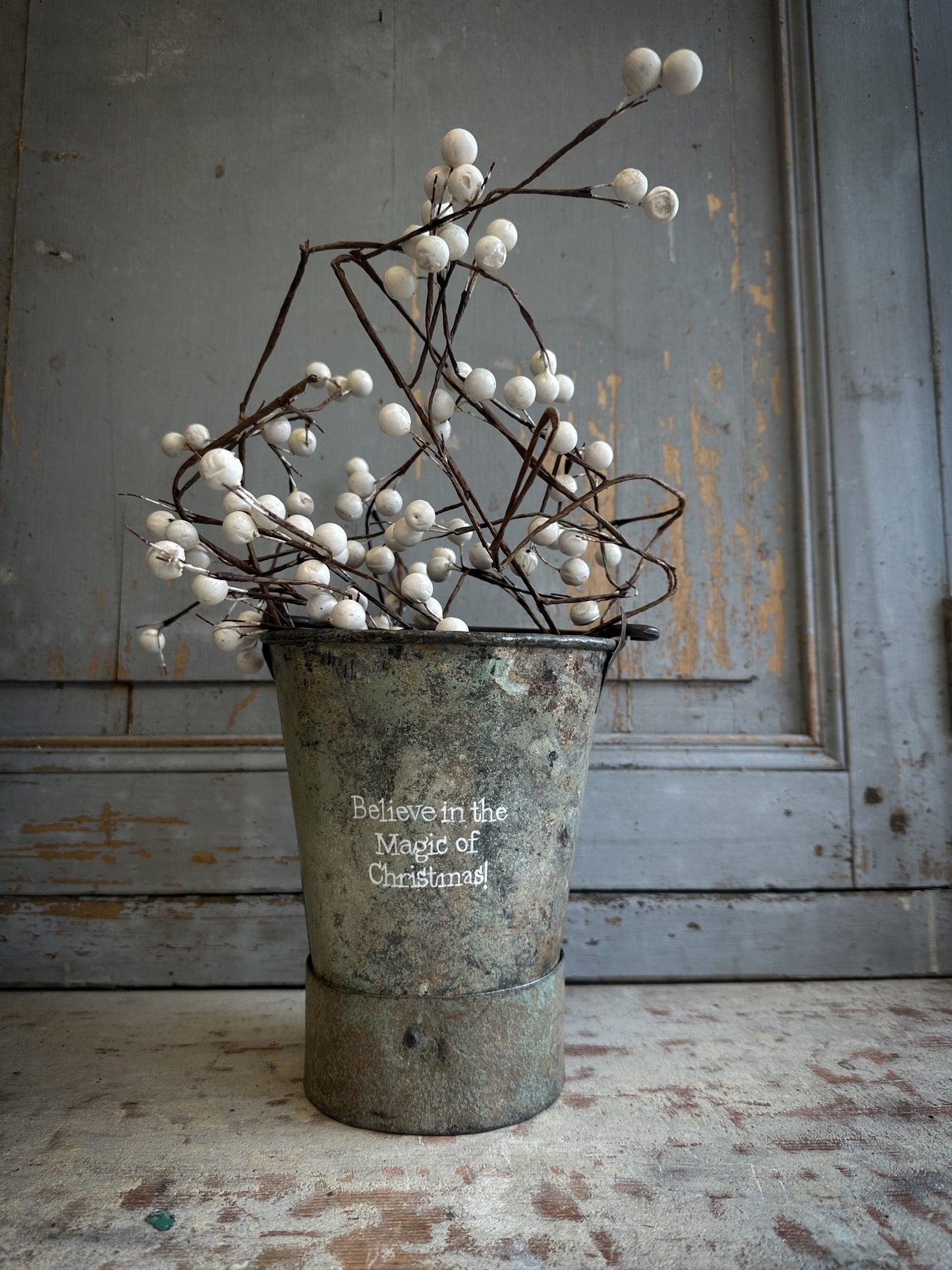 A Recycled Metal Mini Christmas Tree Bucket With A Hand Painted Quote