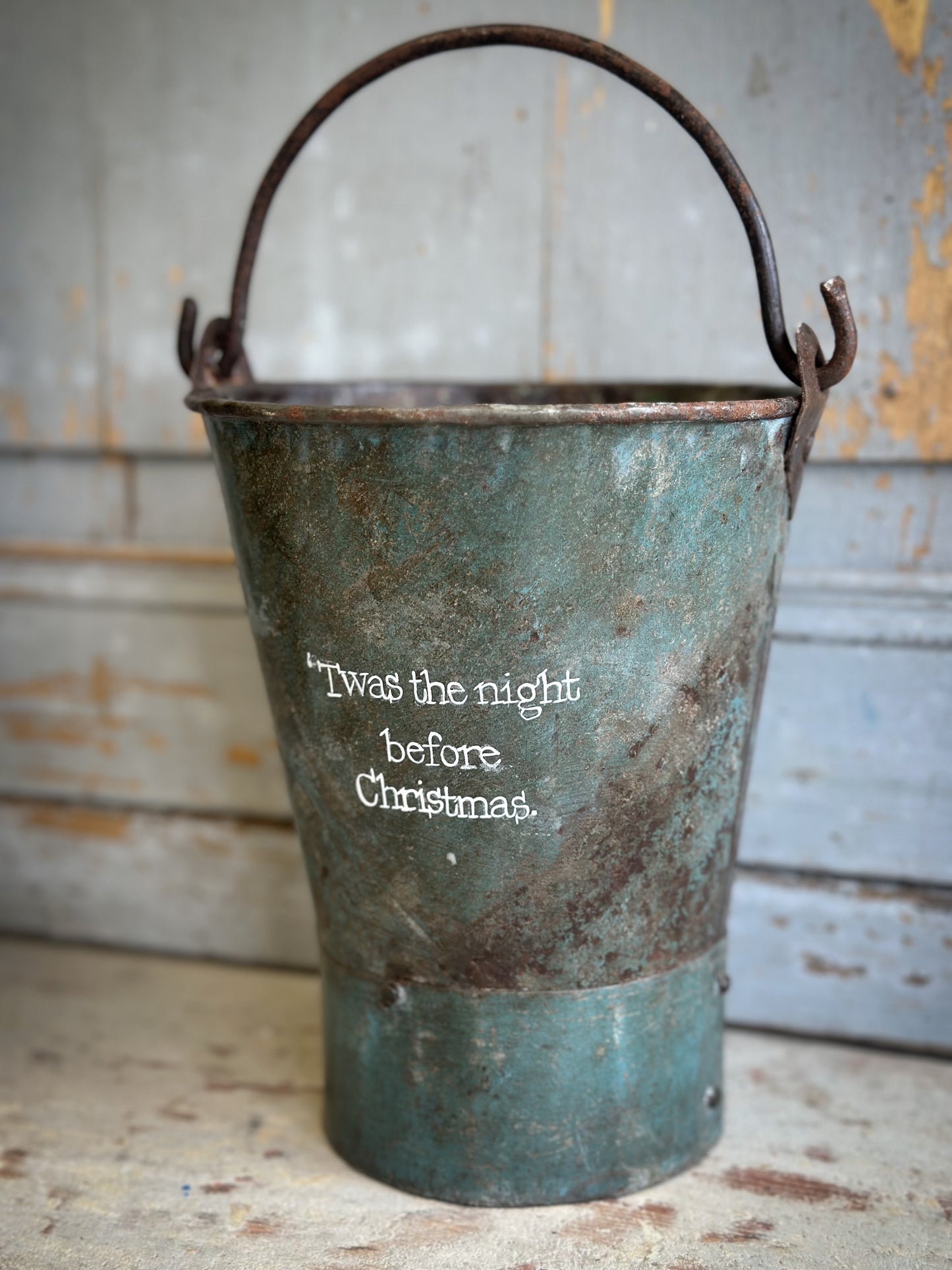 A Recycled Metal Mini Christmas Tree Bucket With A Hand Painted Quote