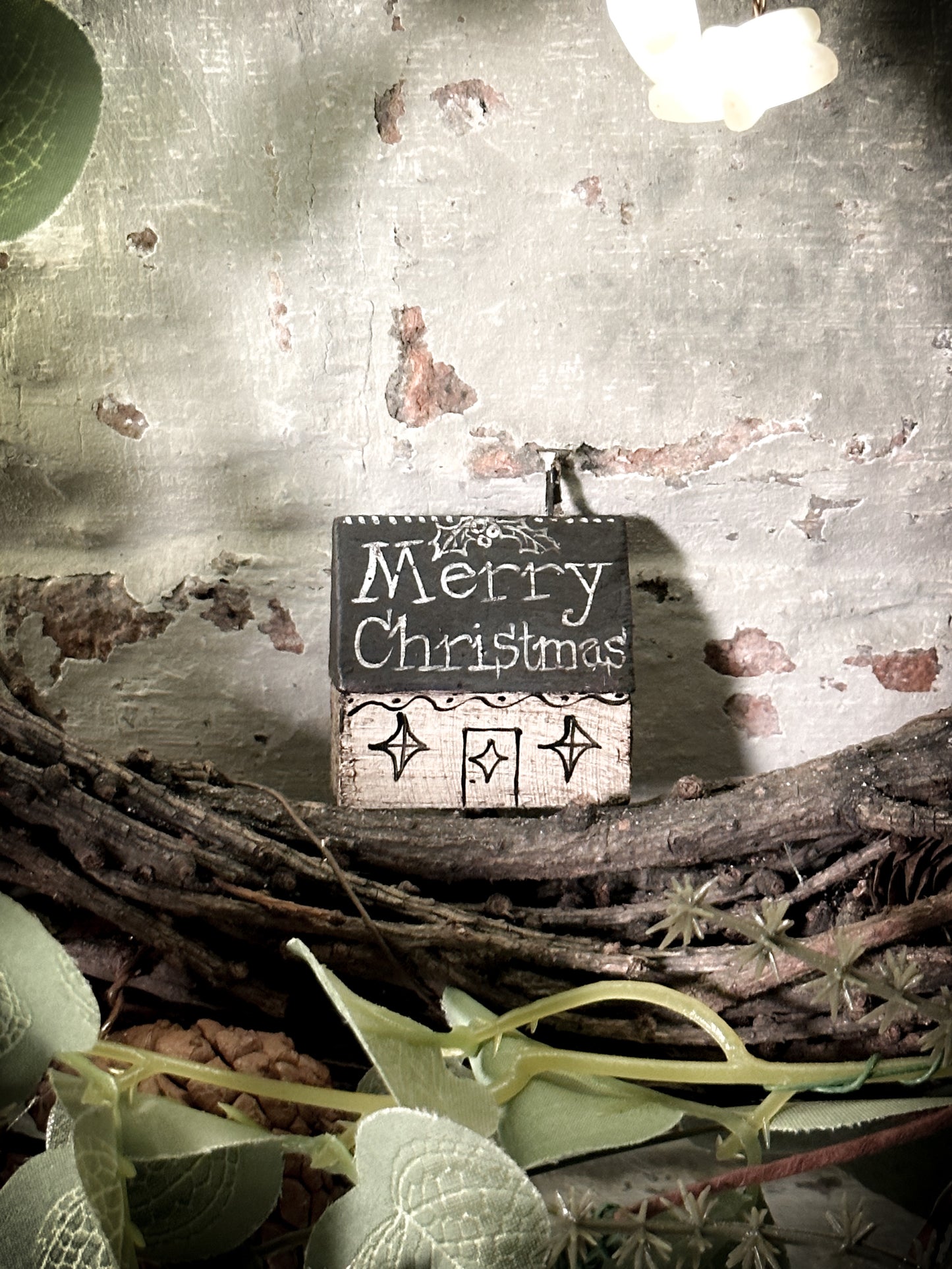 A pretty vintage German Erzgebirge Putz wooden village house painted with a Christmas quote