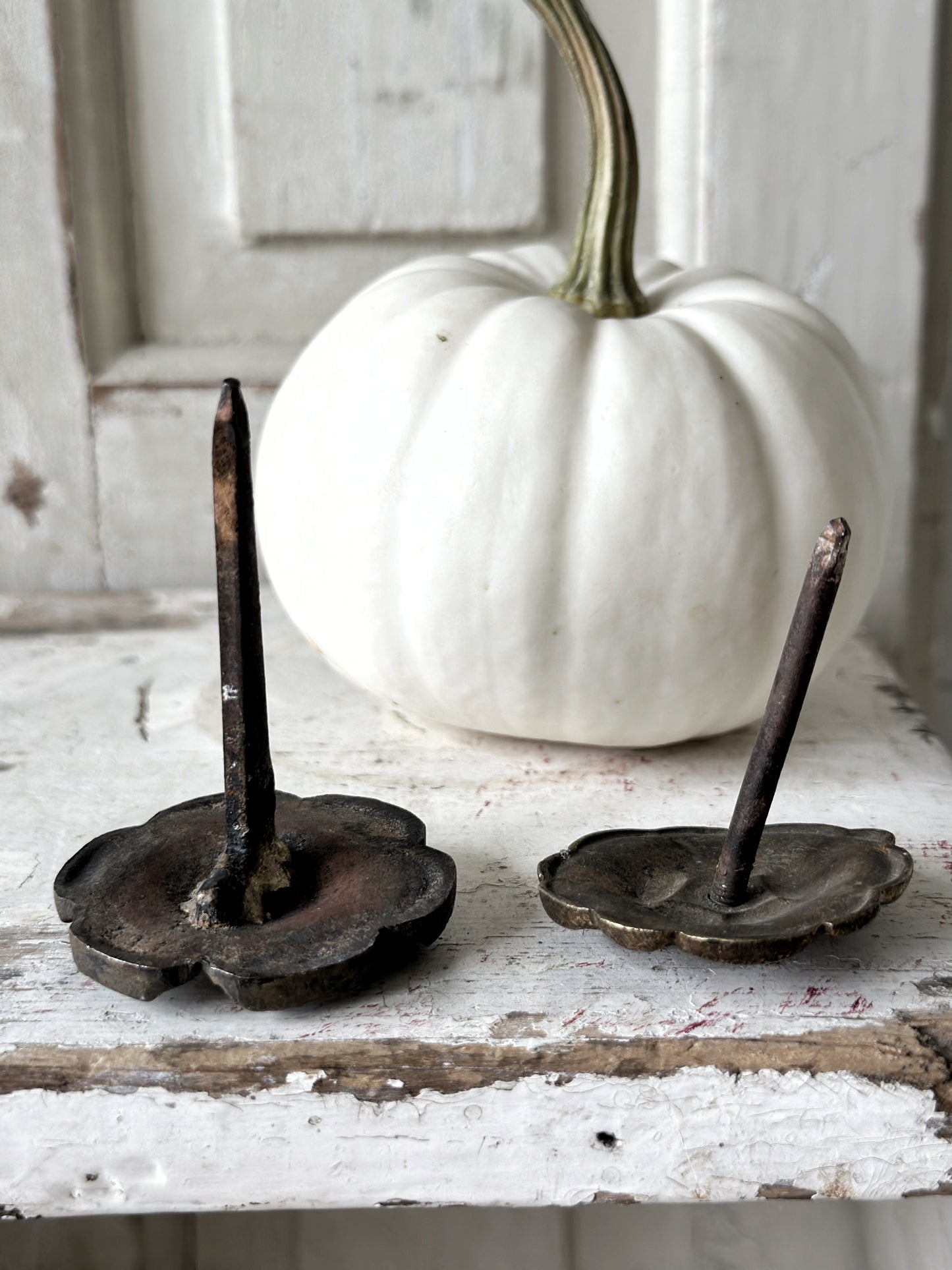 A pair of antique brass salvaged French curtain tie back hooks