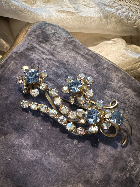 A pretty vintage Aurora Borealis and paste sapphire flower brooch