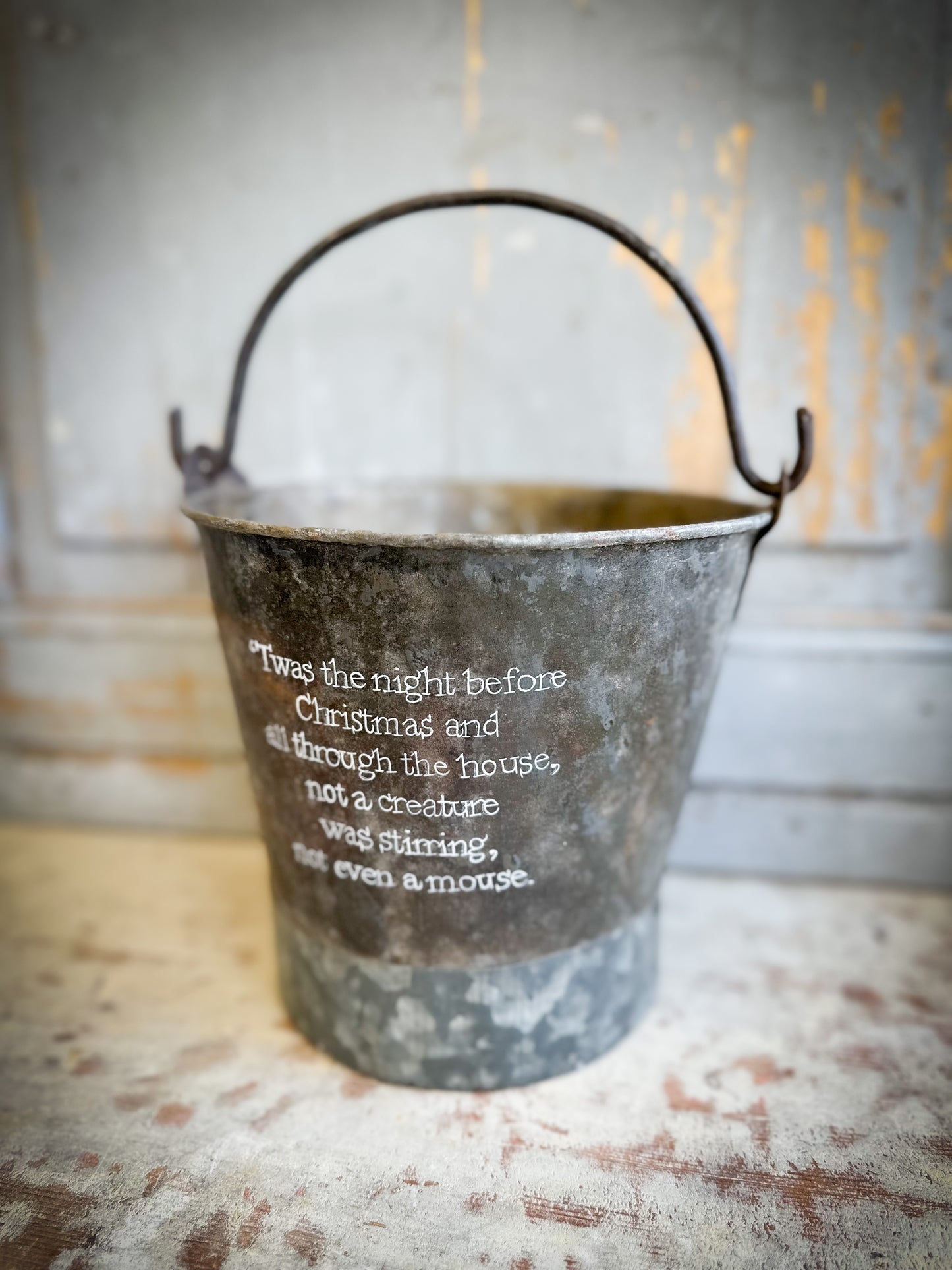 A Recycled Metal Small Christmas Tree Bucket With A Hand Painted Quote