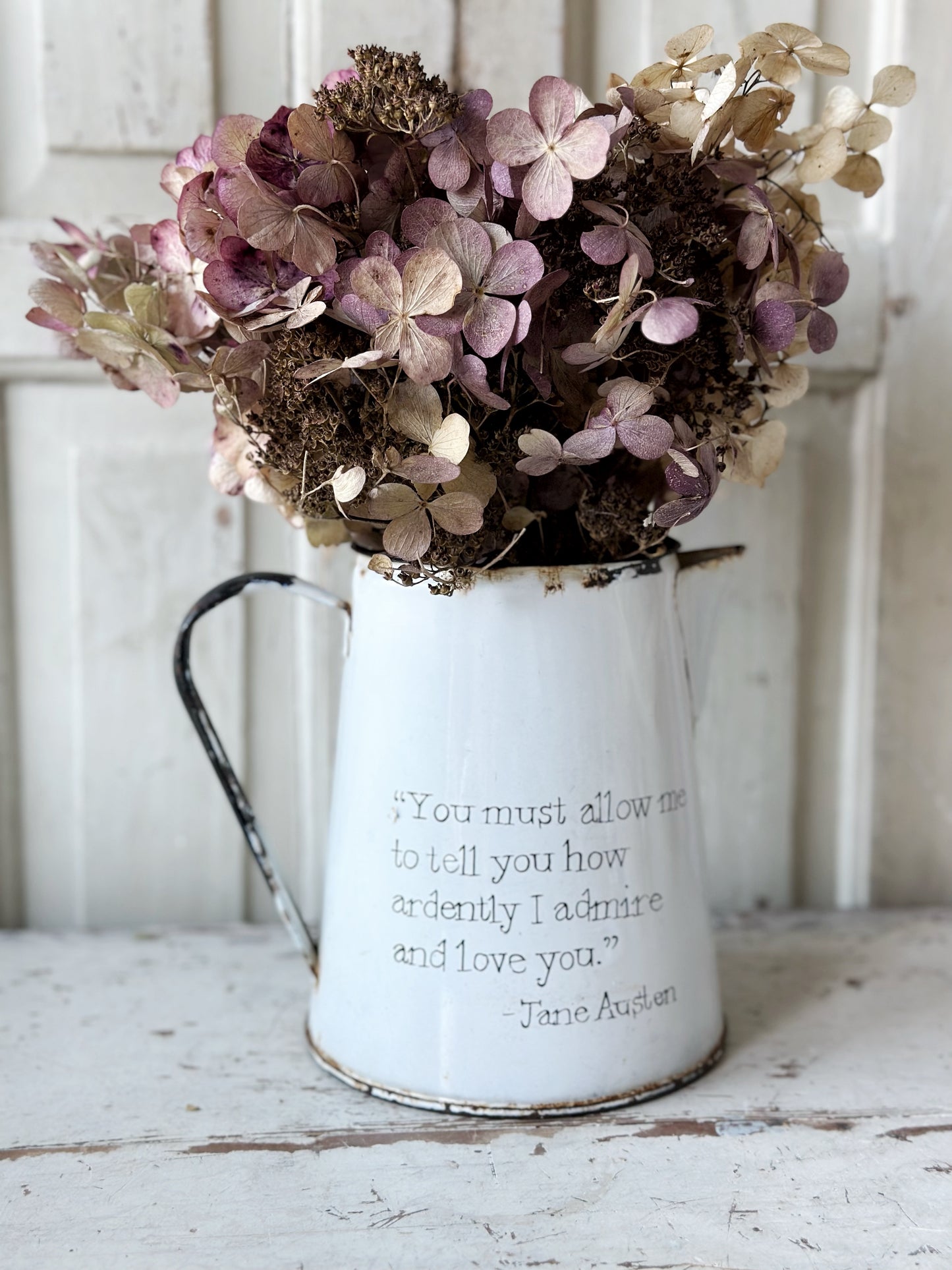 A hand painted quote on a beautiful Vintage white enamelware jug