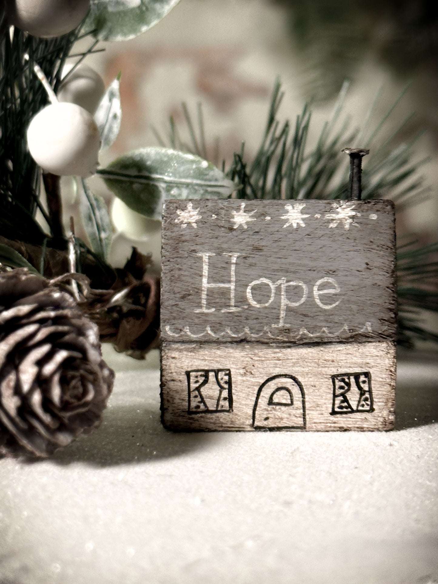 A pretty vintage German Erzgebirge Putz wooden village house painted with a Christmas quote