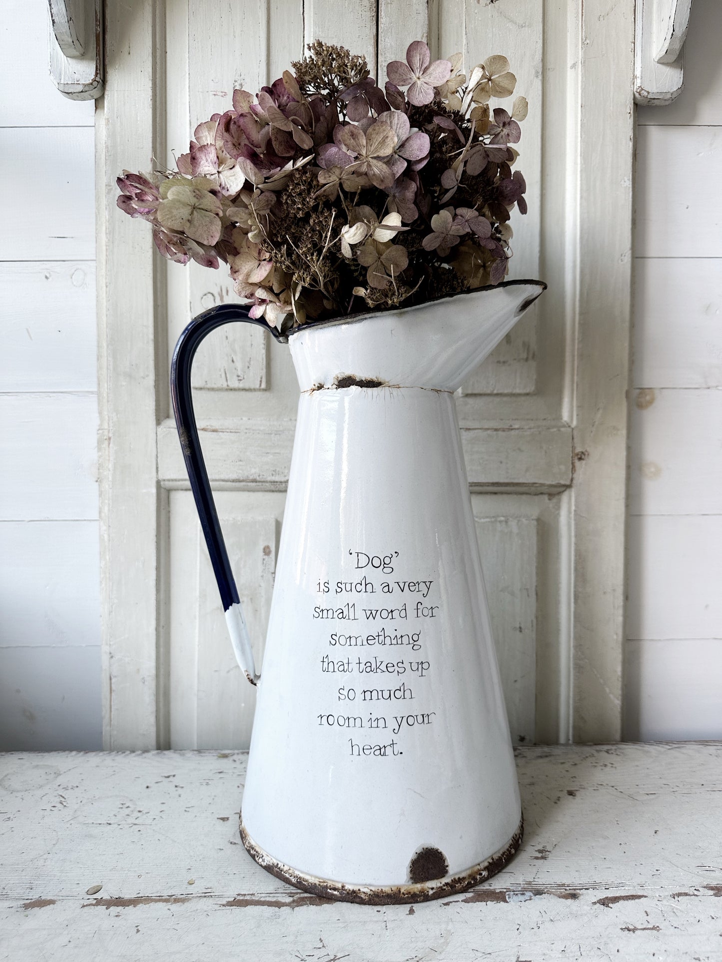 A hand painted quote on a beautiful Vintage white enamelware jug