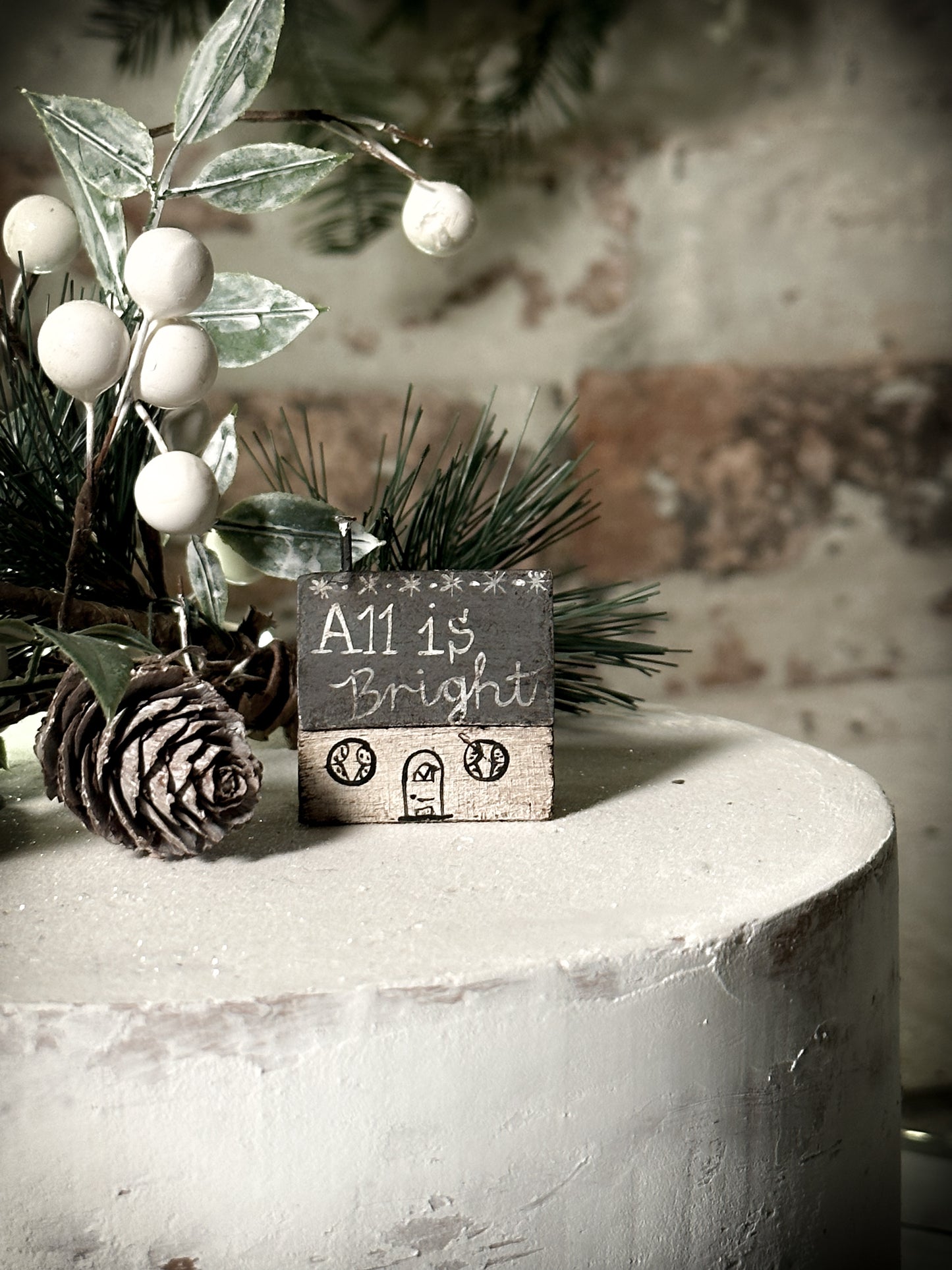 A pretty vintage German Erzgebirge Putz wooden village house painted with a Christmas quote