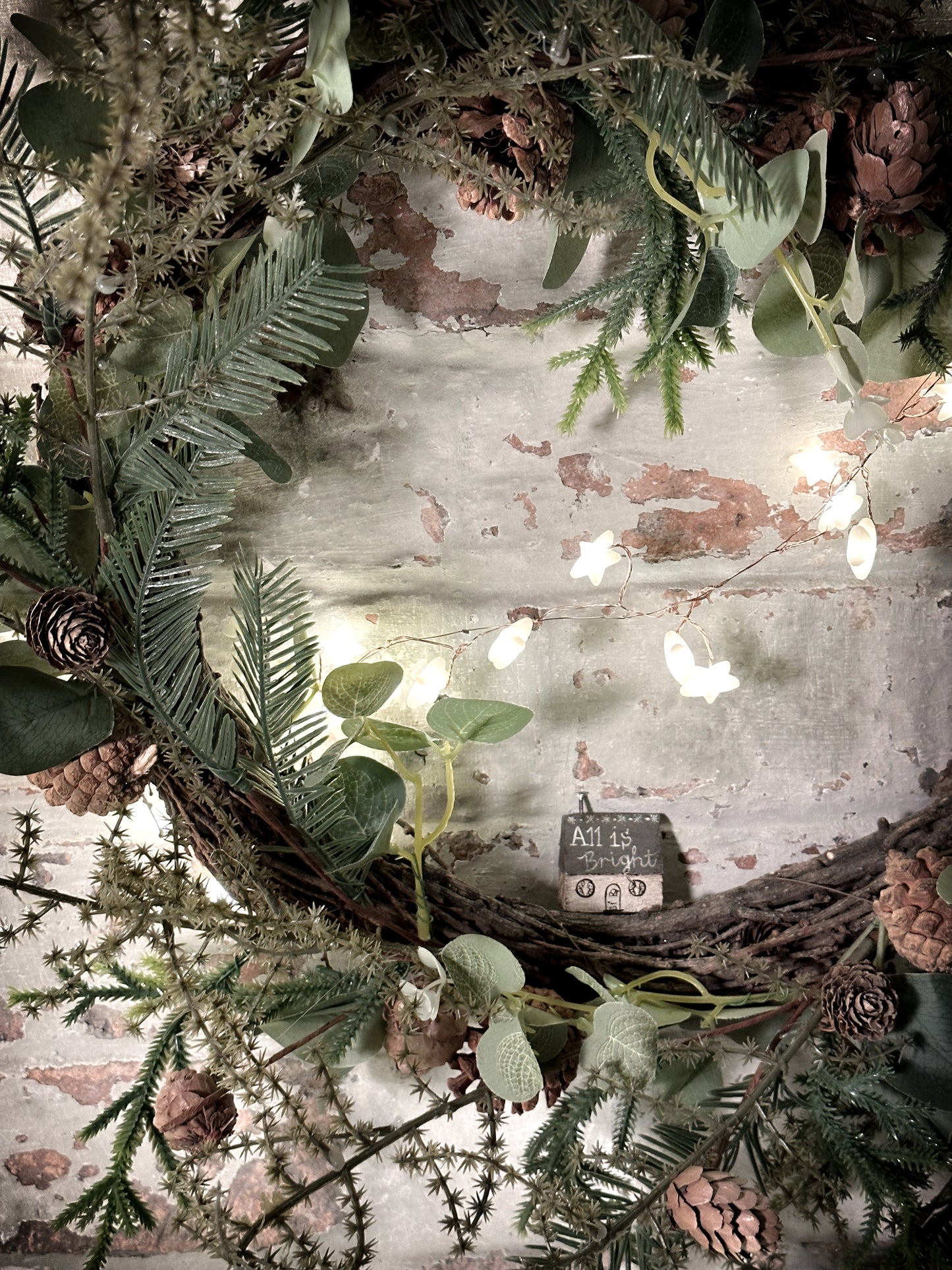 A pretty vintage German Erzgebirge Putz wooden village house painted with a Christmas quote