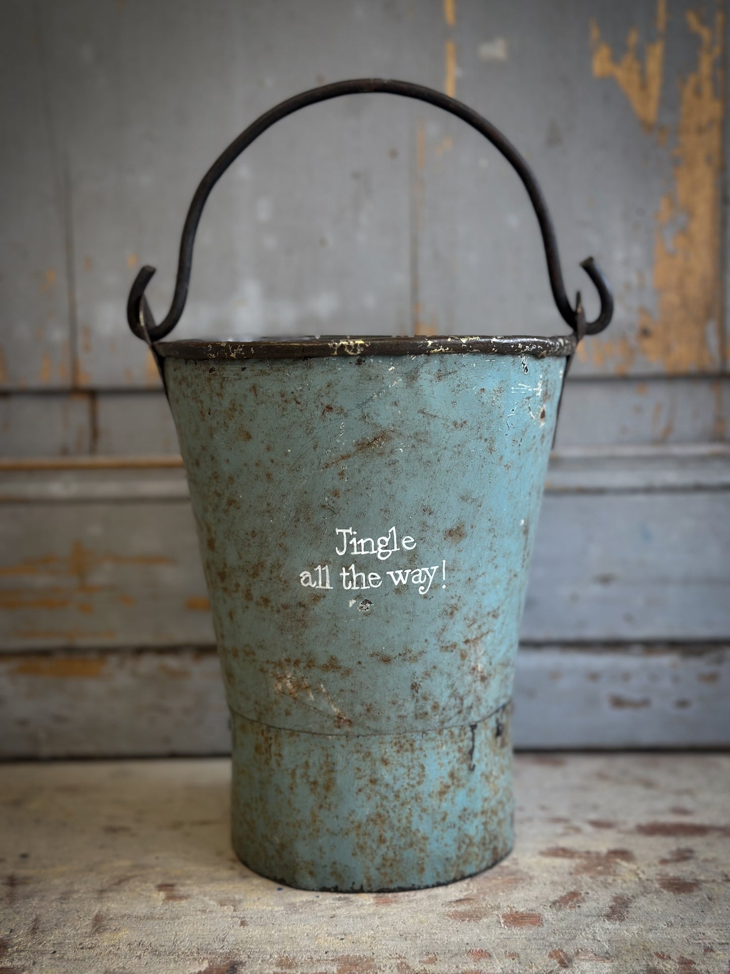 A Recycled Metal Mini Christmas Tree Bucket With A Hand Painted Quote