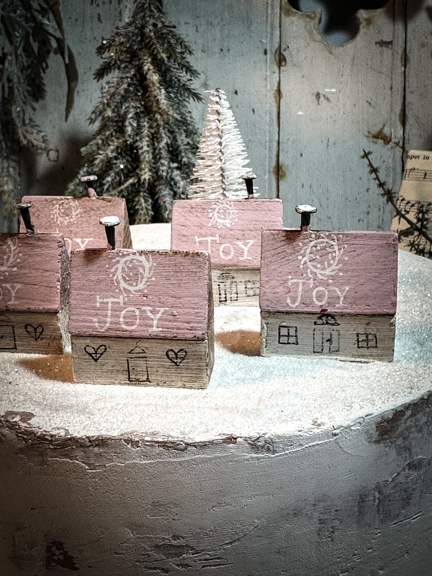 A pretty vintage German Erzgebirge Putz wooden village house painted with a Christmas quote