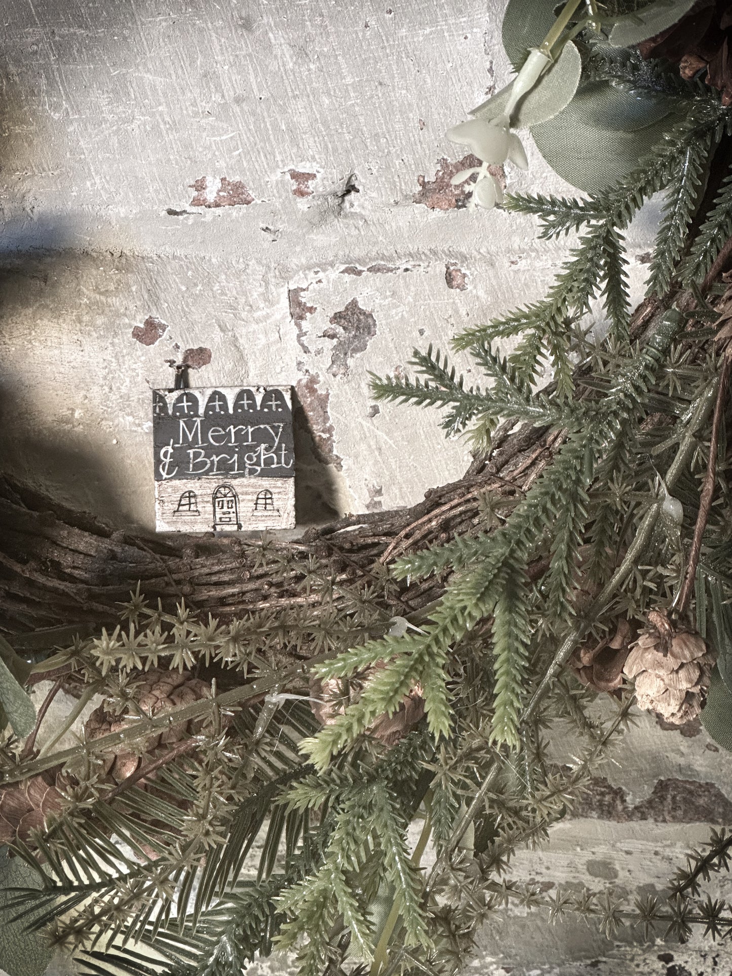 A pretty vintage German Erzgebirge Putz wooden village house painted with a Christmas quote