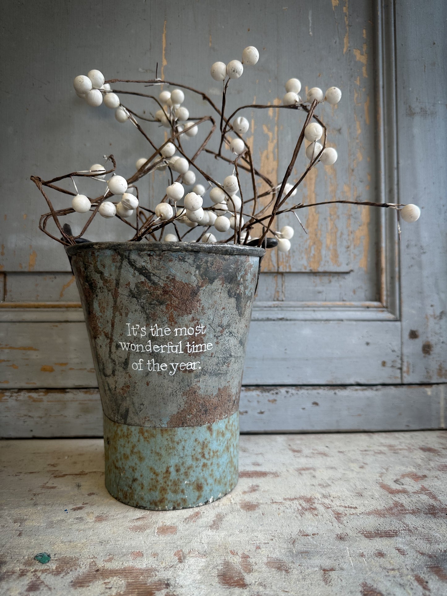 A Recycled Metal Mini Christmas Tree Bucket With A Hand Painted Quote