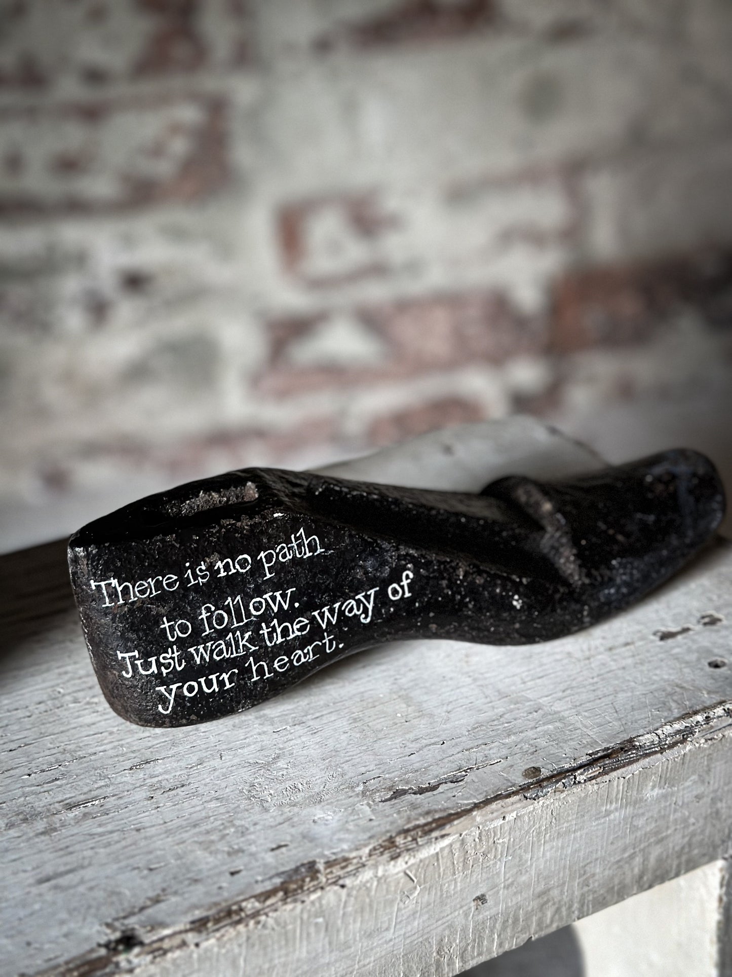 An antique cast iron painted adult’s shoe last.