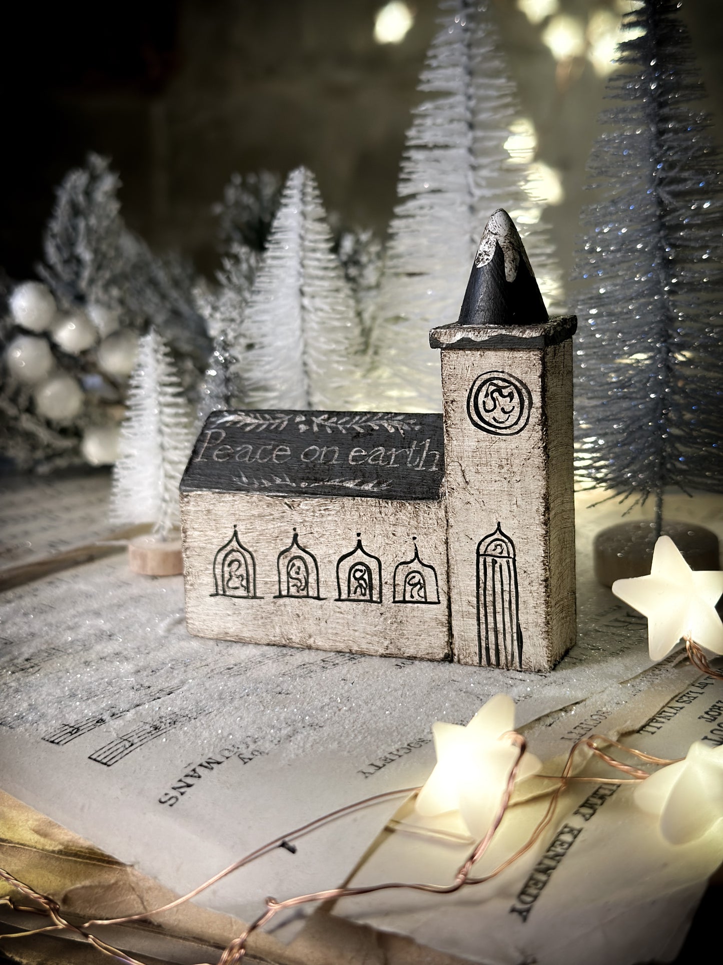 A pretty vintage German Erzgebirge Putz wooden village house painted with a Christmas quote