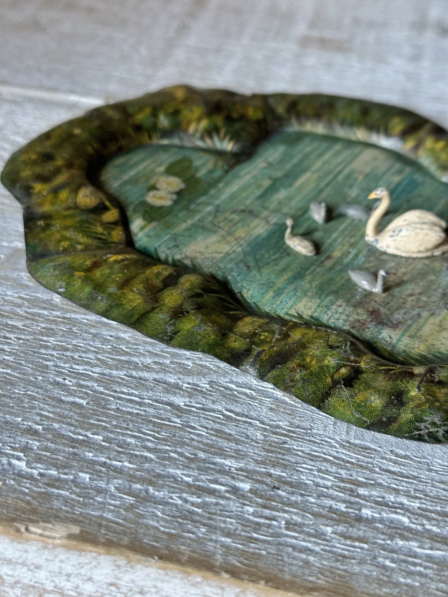 A beautiful pre-war tinplate duck pond with a Britains die cast Swan and four cygnets