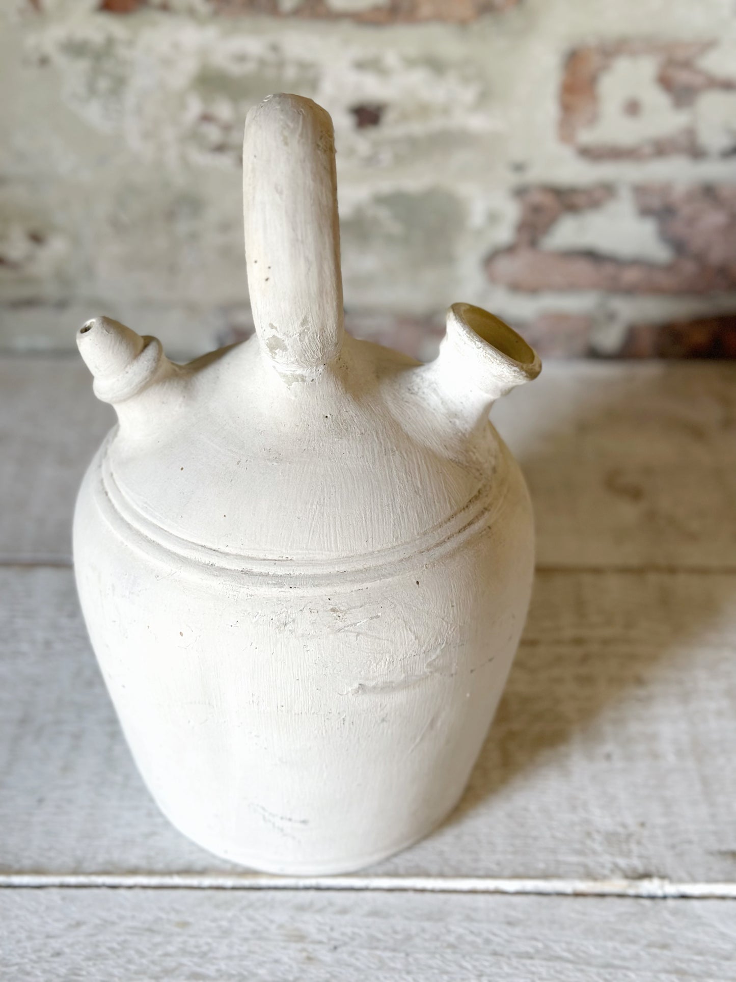 A vintage French stoneware gargoulette water bottle