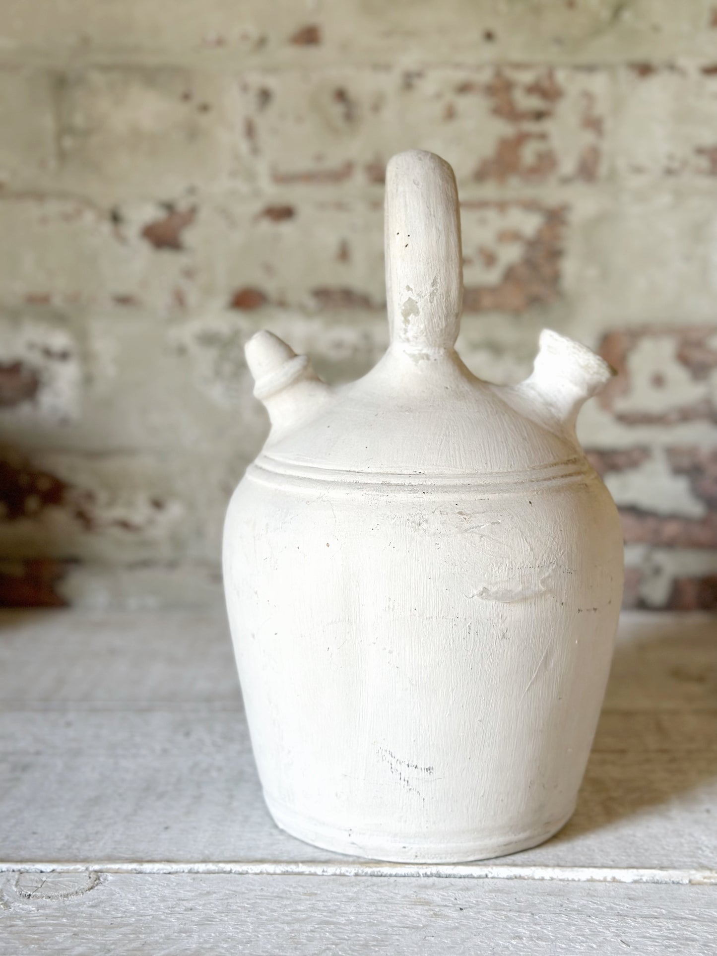 A vintage French stoneware gargoulette water bottle