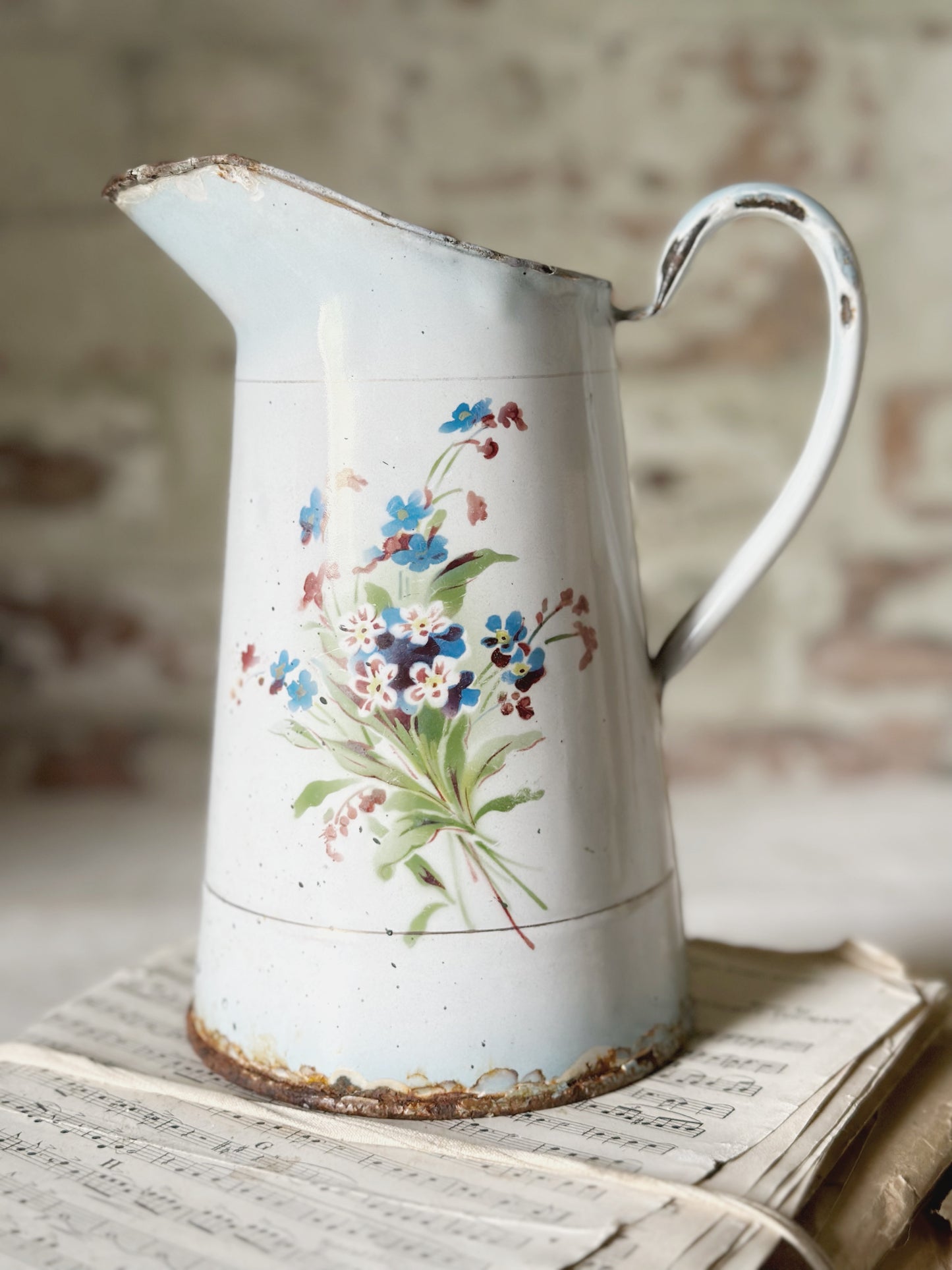 A beautiful French antique enamel jug with floral detail