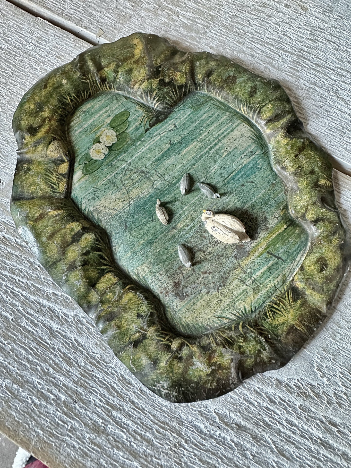 A beautiful pre-war tinplate duck pond with a Britains die cast Swan and four cygnets