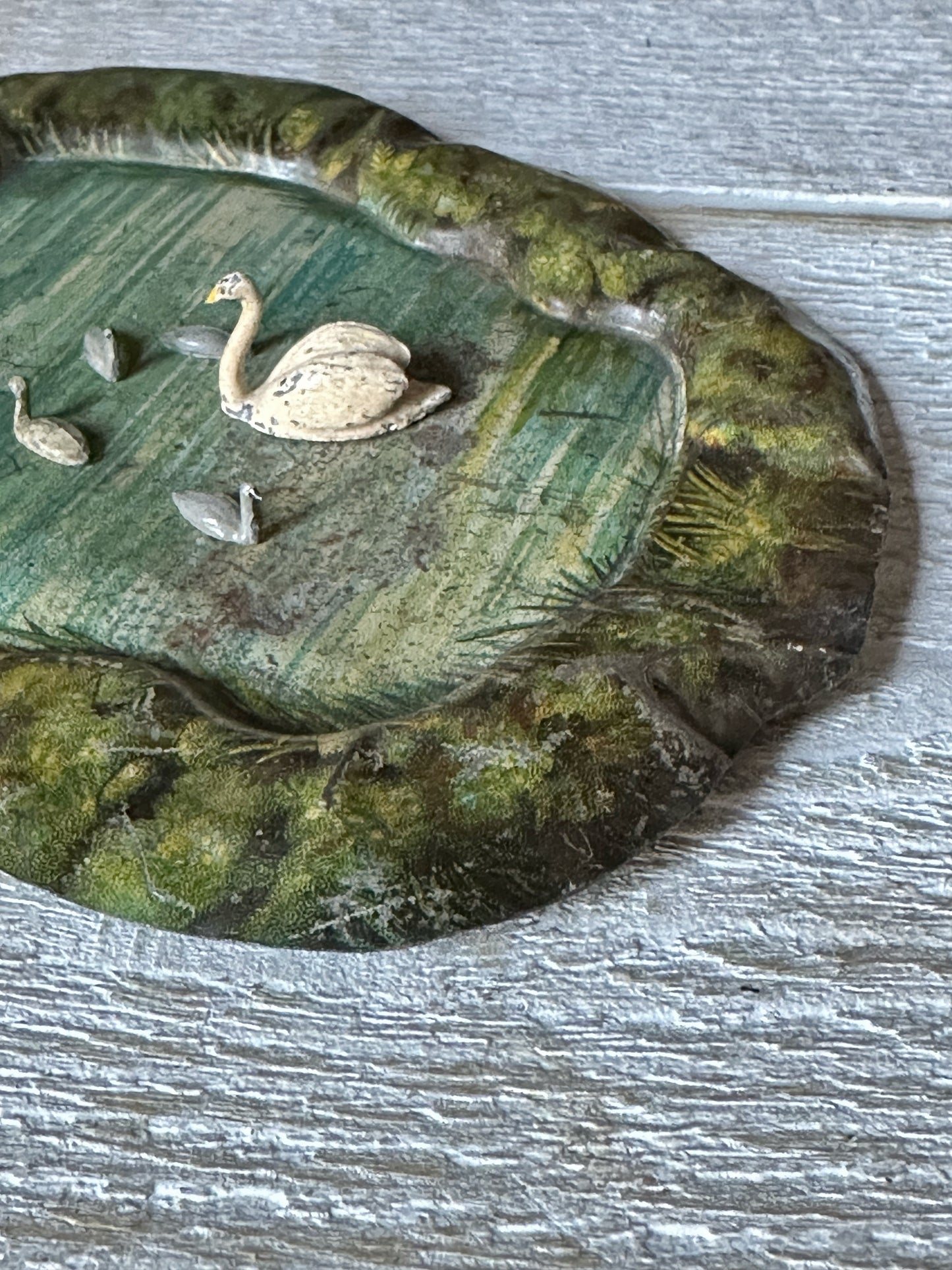 A beautiful pre-war tinplate duck pond with a Britains die cast Swan and four cygnets