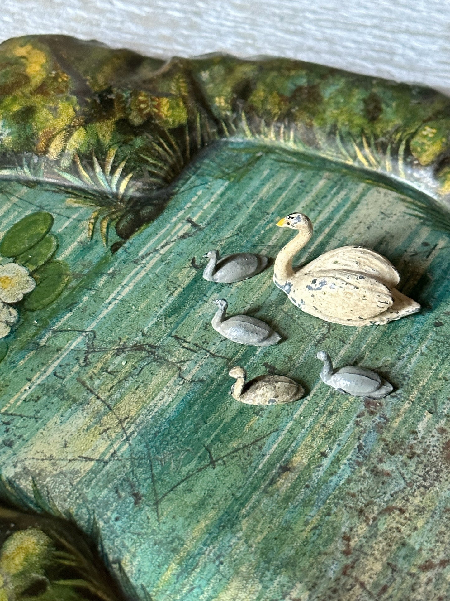 A beautiful pre-war tinplate duck pond with a Britains die cast Swan and four cygnets