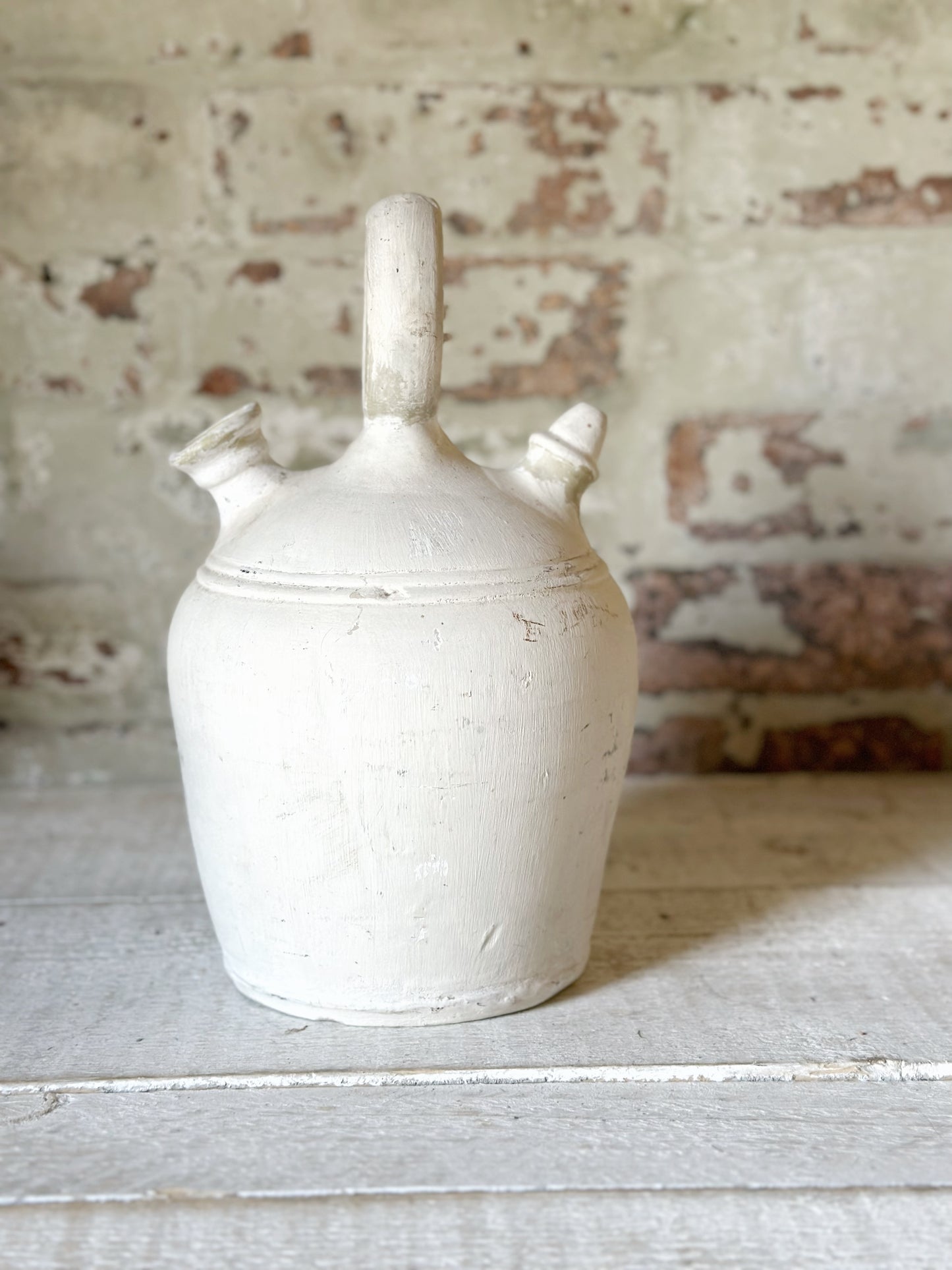 A vintage French stoneware gargoulette water bottle
