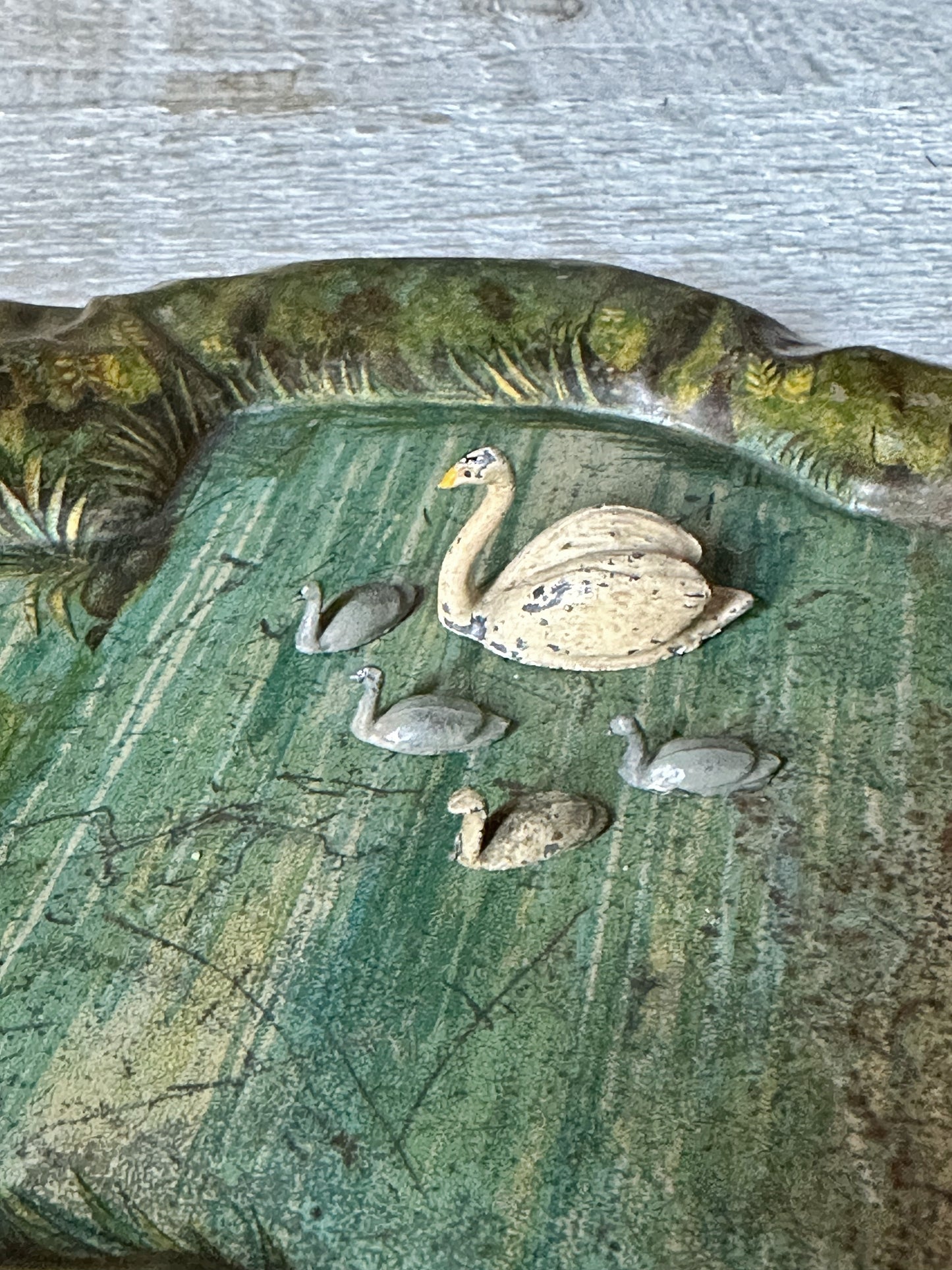 A beautiful pre-war tinplate duck pond with a Britains die cast Swan and four cygnets