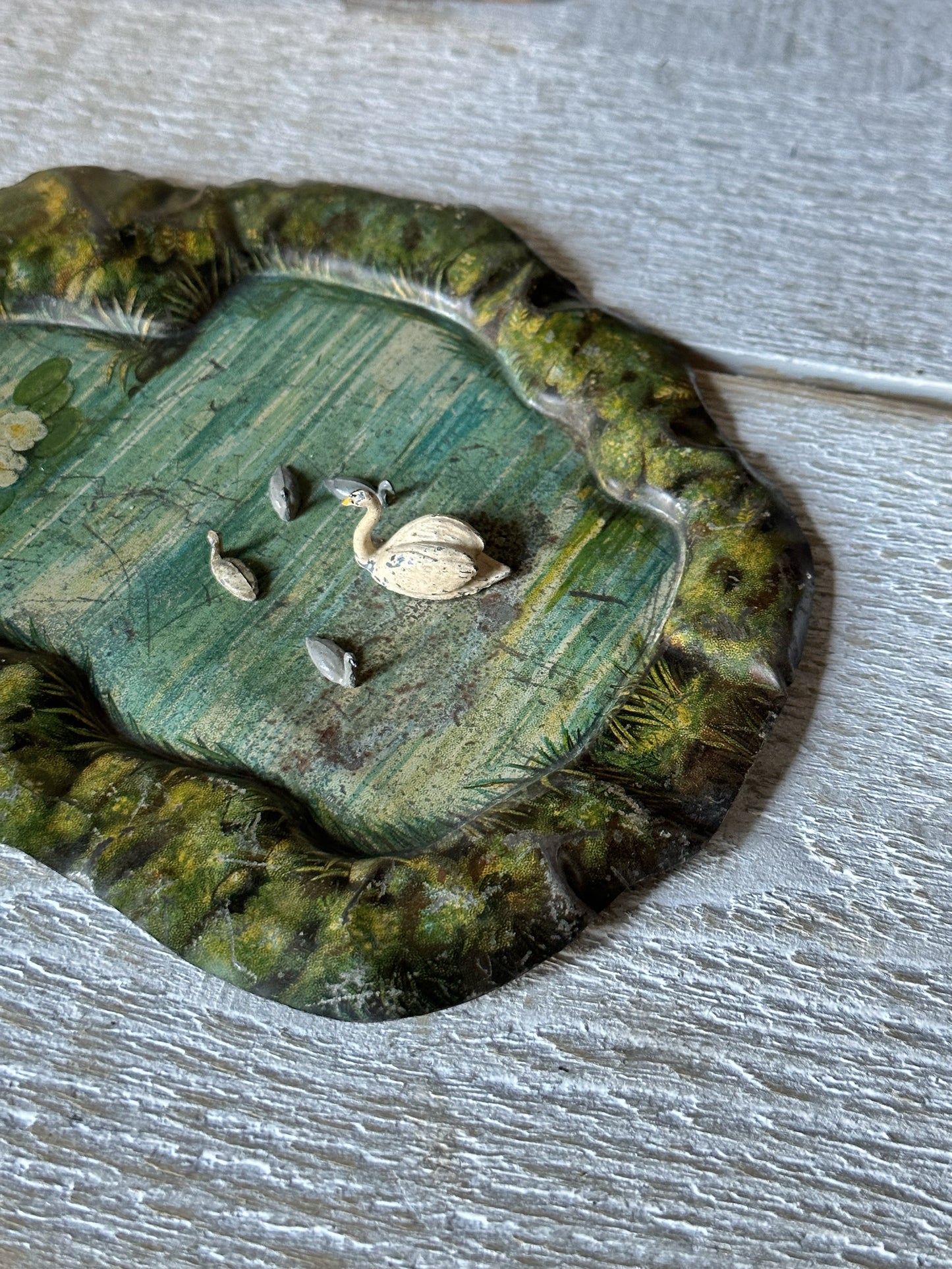 A beautiful pre-war tinplate duck pond with a Britains die cast Swan and four cygnets