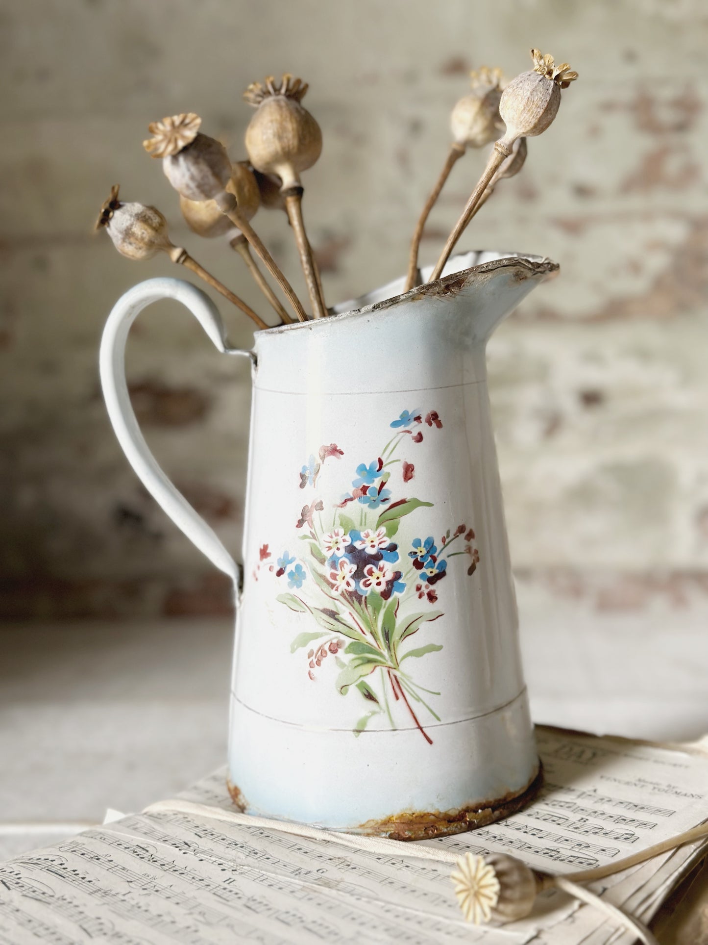 A beautiful French antique enamel jug with floral detail