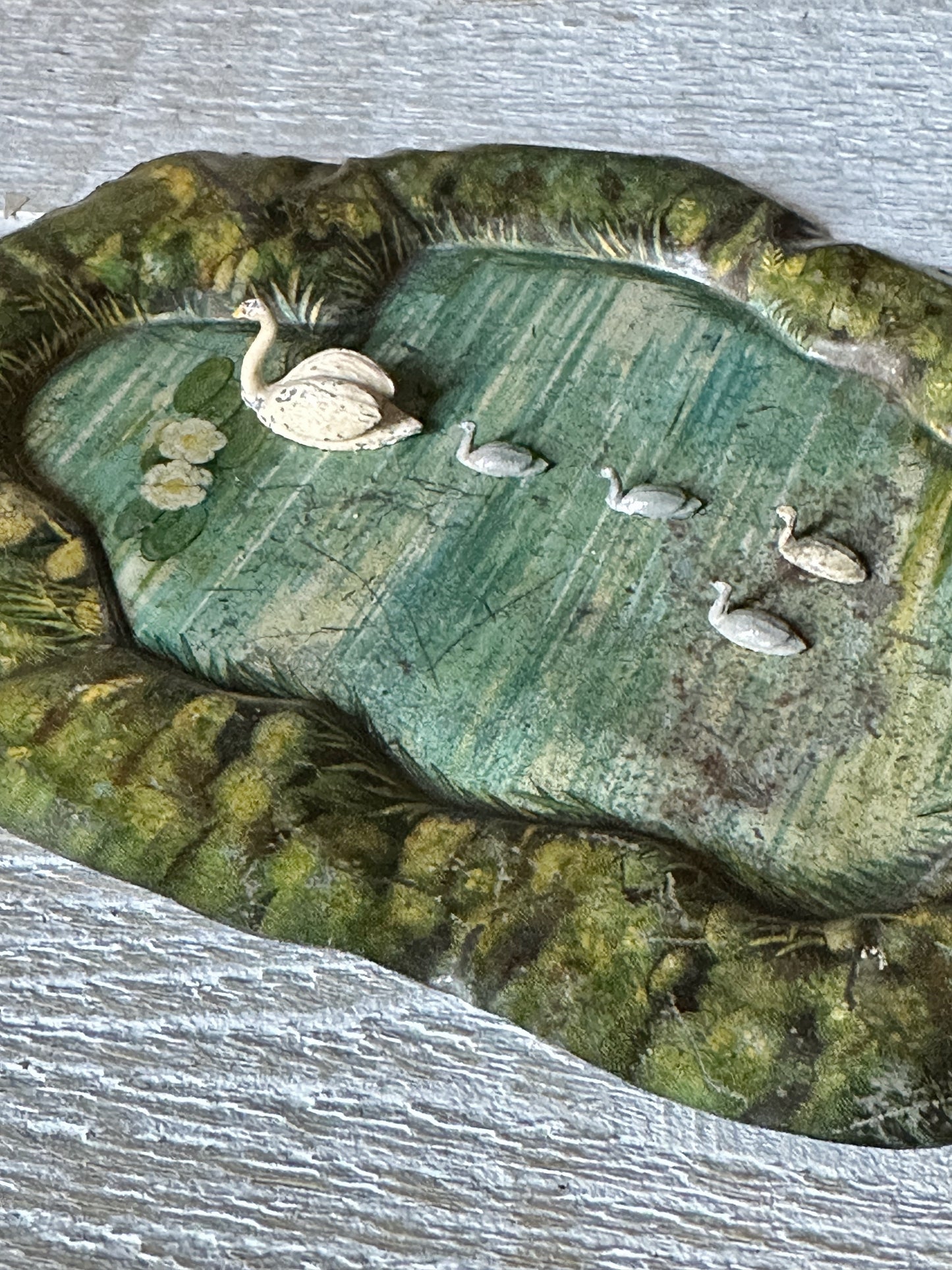 A beautiful pre-war tinplate duck pond with a Britains die cast Swan and four cygnets