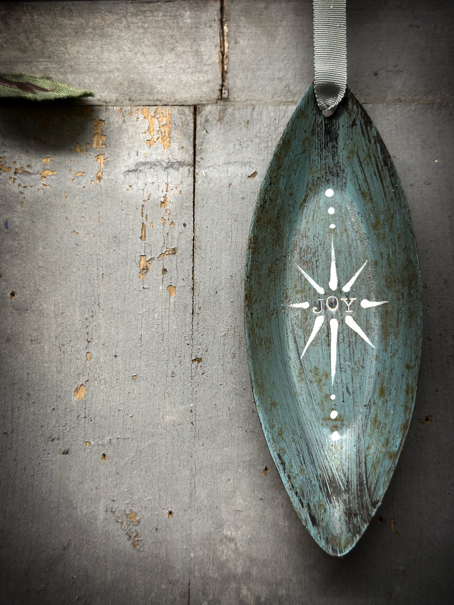 A Reworked French Patisserie Tin Christmas Decoration Stamped and Painted “Joy”