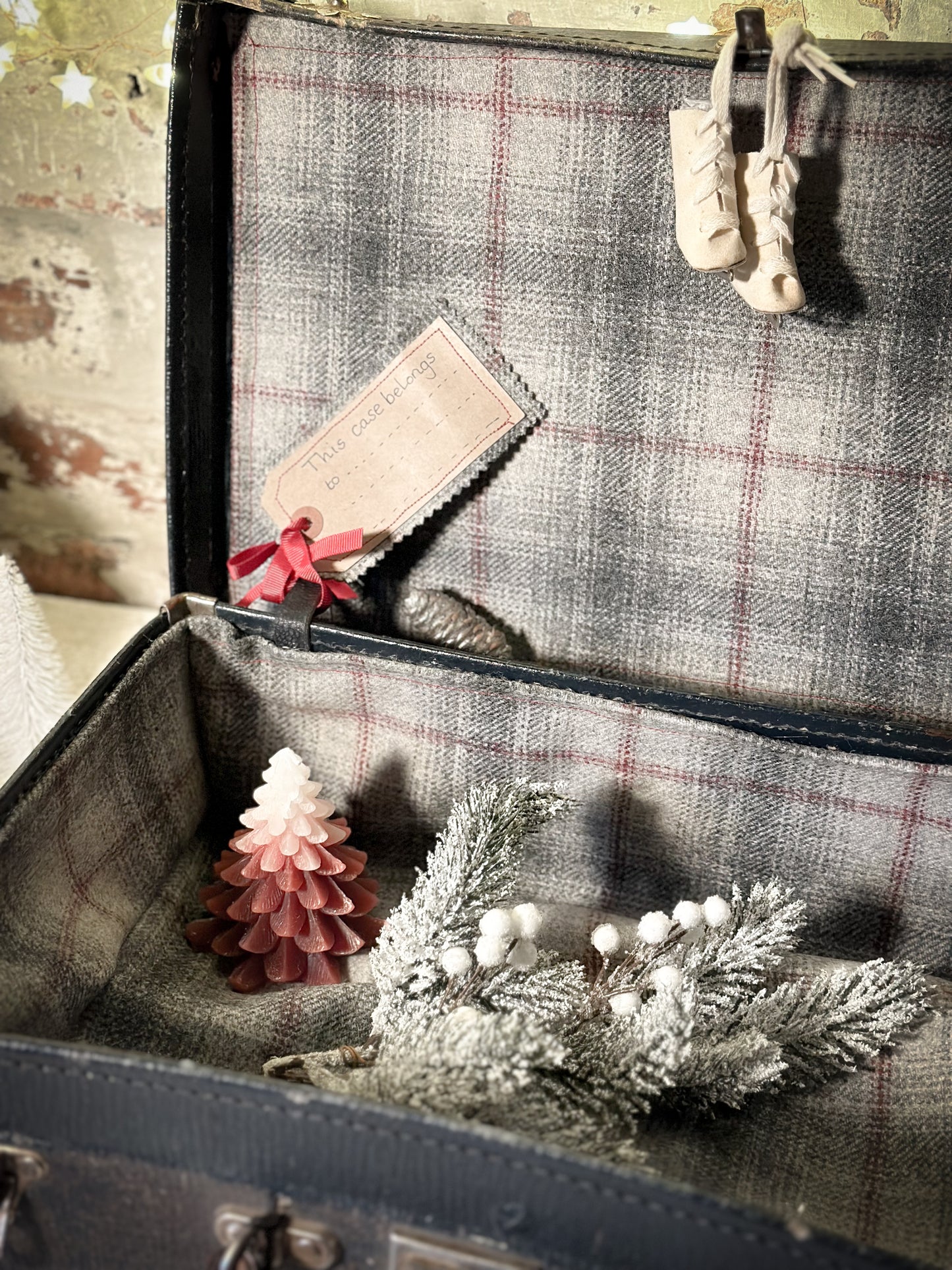 A gorgeous vintage suitcase with a hand painted quote for storing Christmas decorations