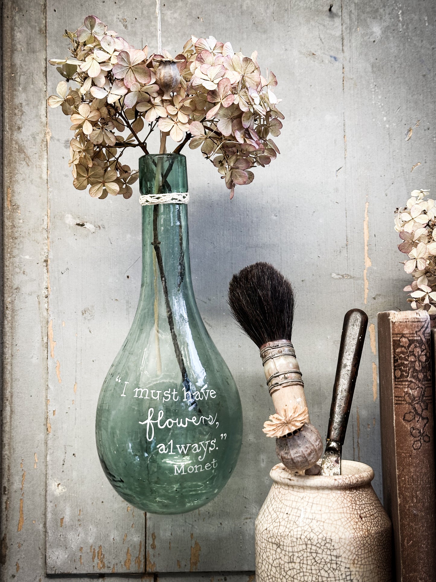 A beautiful antique hanging bulb bottle with a hand painted quote