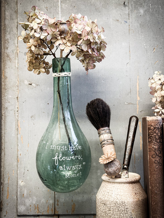 A beautiful antique hanging bulb bottle with a hand painted quote