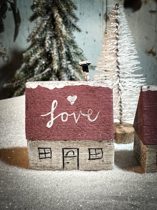 A pretty vintage German Erzgebirge Putz wooden village house painted with a Christmas quote