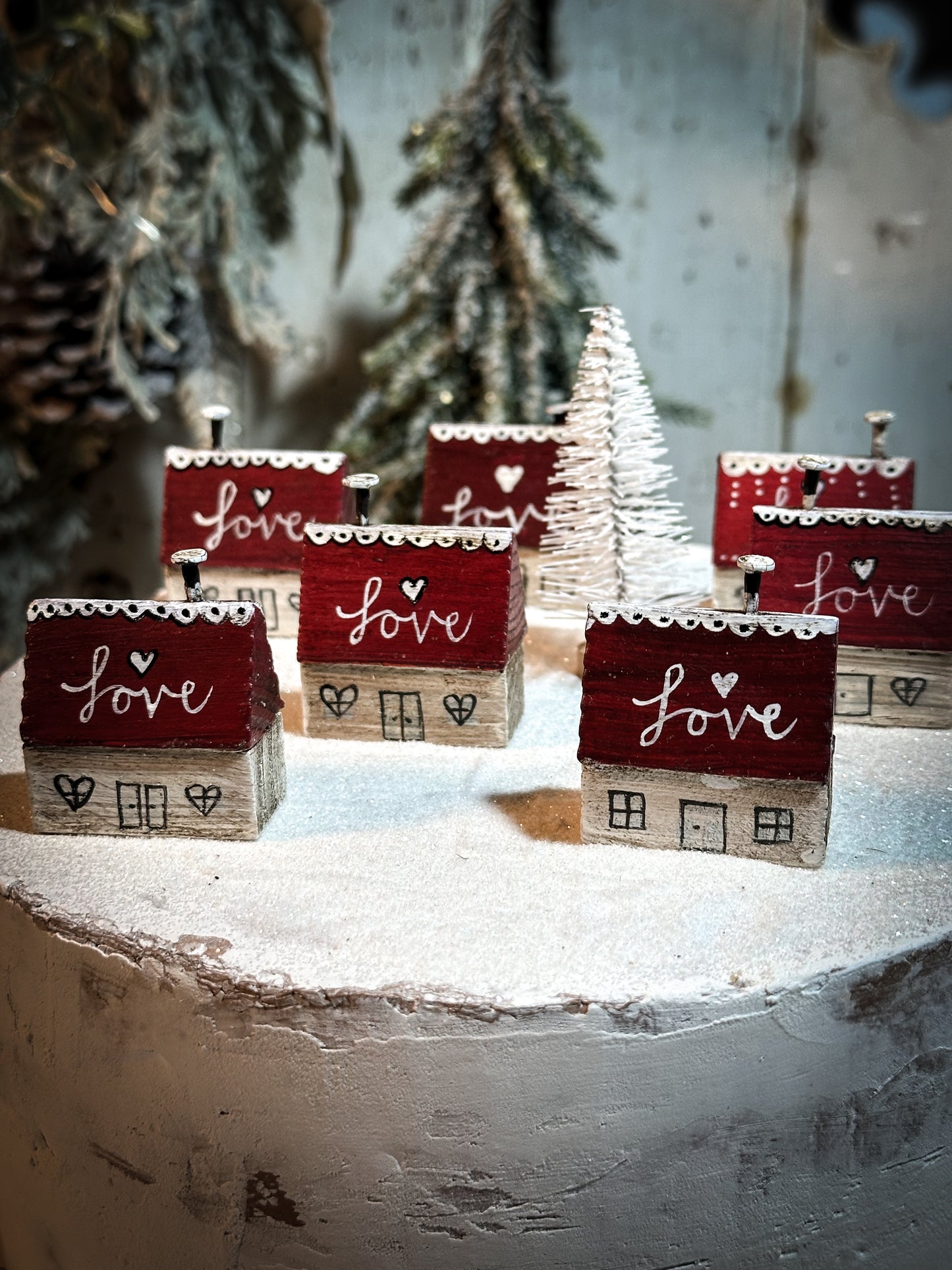 A pretty vintage German Erzgebirge Putz wooden village house painted with a Christmas quote