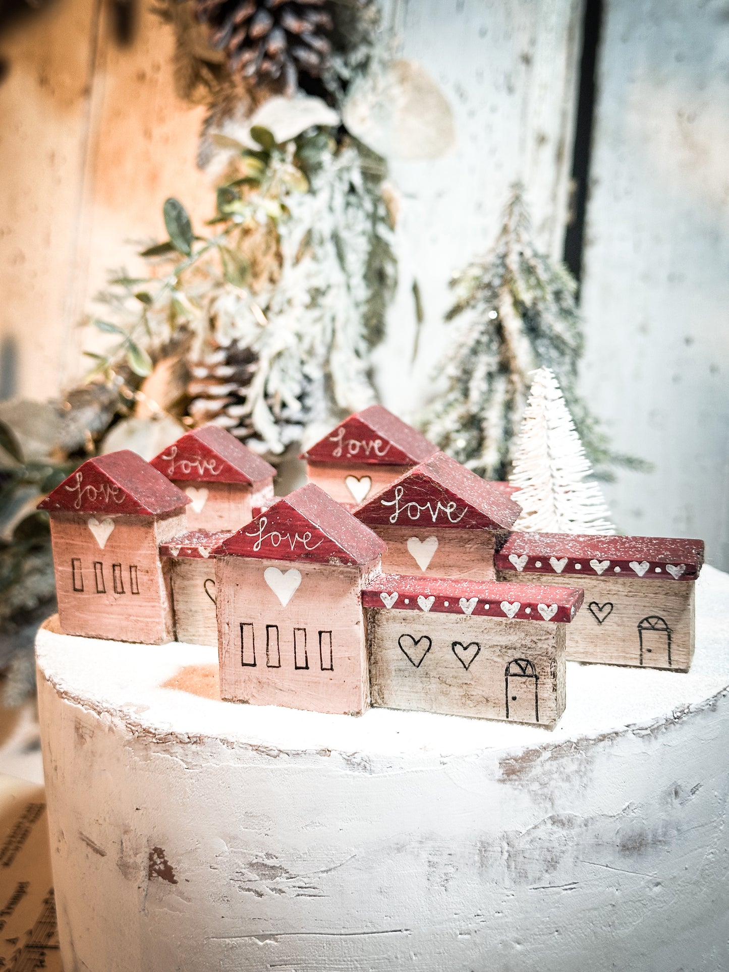 A pretty vintage German Erzgebirge Putz wooden village house painted with a Christmas quote