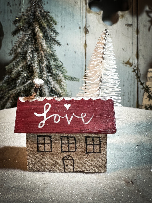 A pretty vintage German Erzgebirge Putz wooden log cabin painted with a Christmas quote