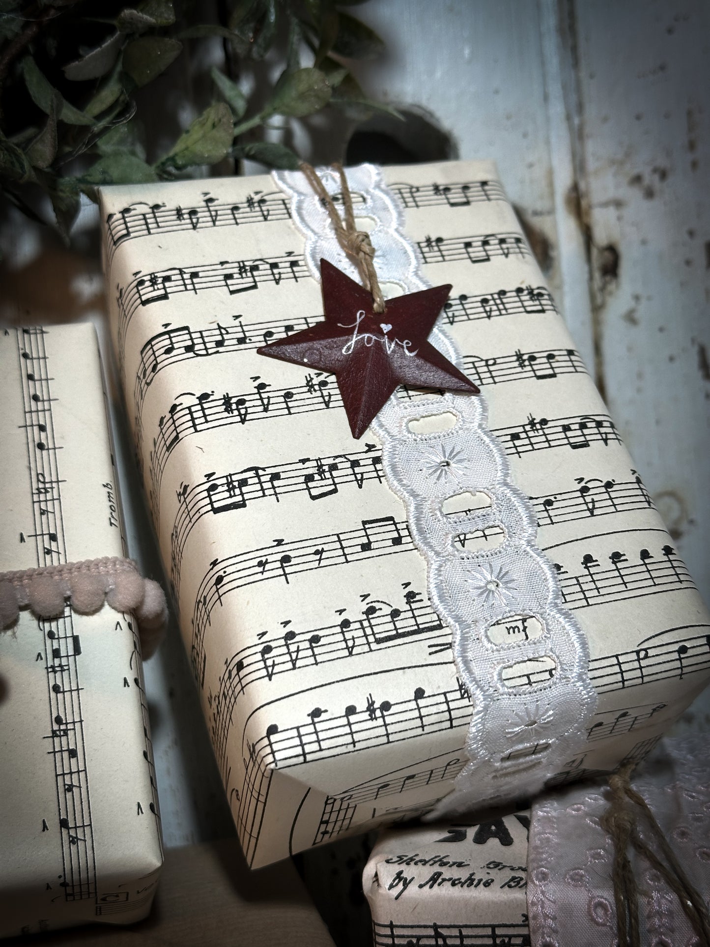 A mini tin barn star pink decoration hand painted with “Joy”