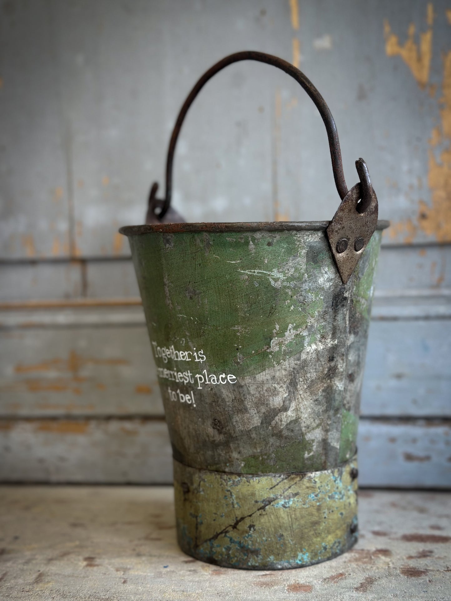 A Recycled Metal Mini Christmas Tree Bucket With A Hand Painted Quote