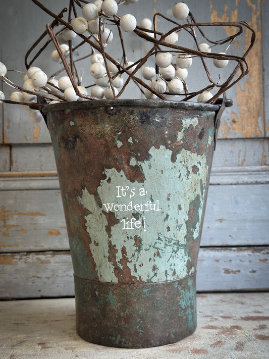 A Recycled Metal Mini Christmas Tree Bucket With A Hand Painted Quote