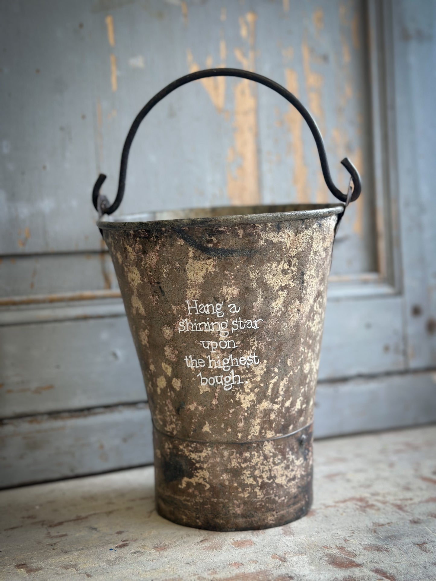 A Recycled Metal Mini Christmas Tree Bucket With A Hand Painted Quote