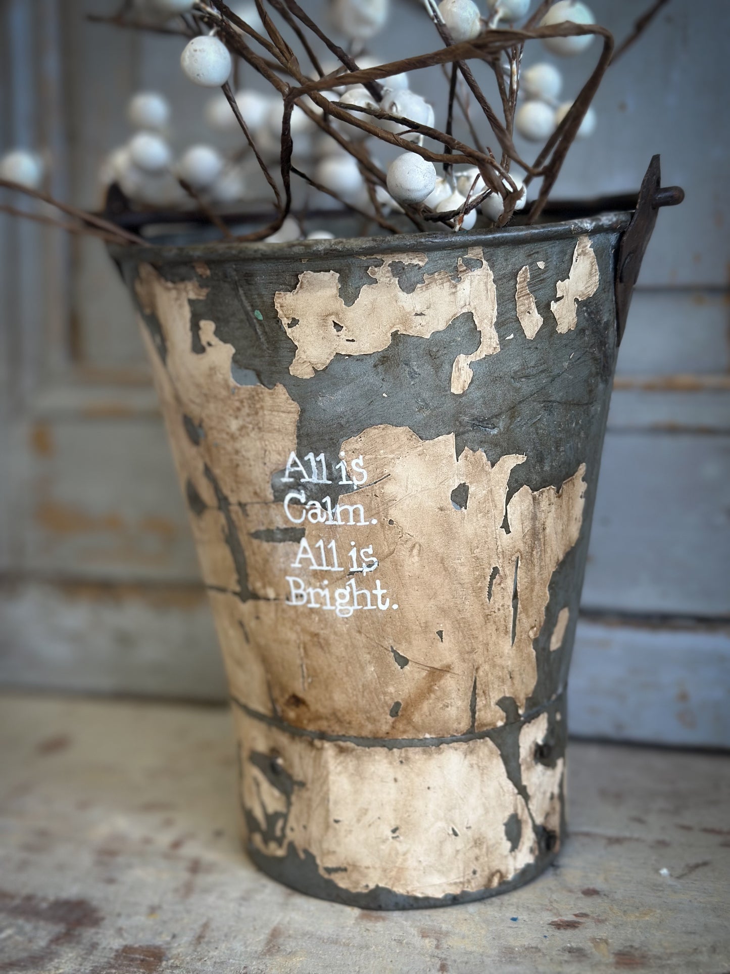 A Recycled Metal Mini Christmas Tree Bucket With A Hand Painted Quote
