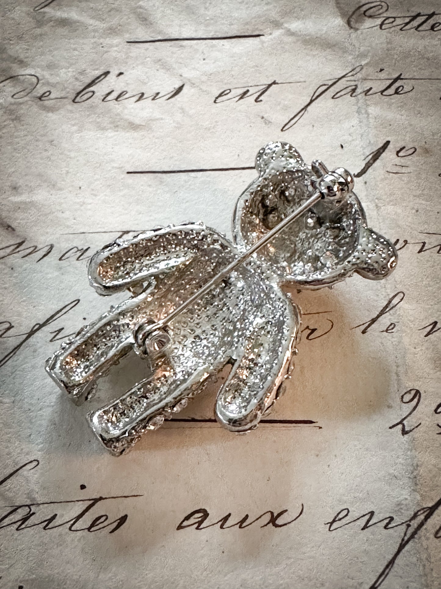 A sweet vintage diamanté teddy bear brooch